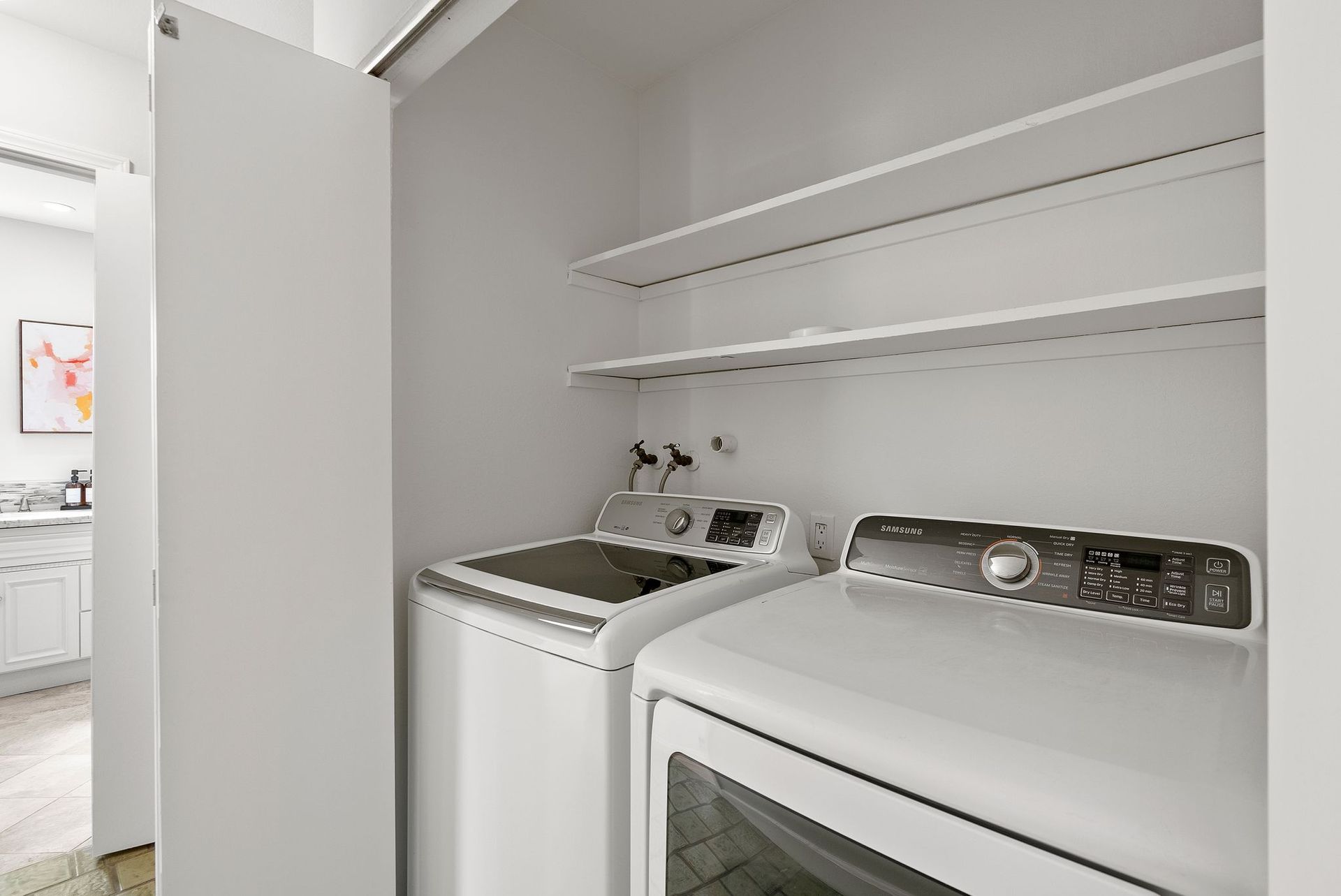 A laundry room with a washer and dryer in it.