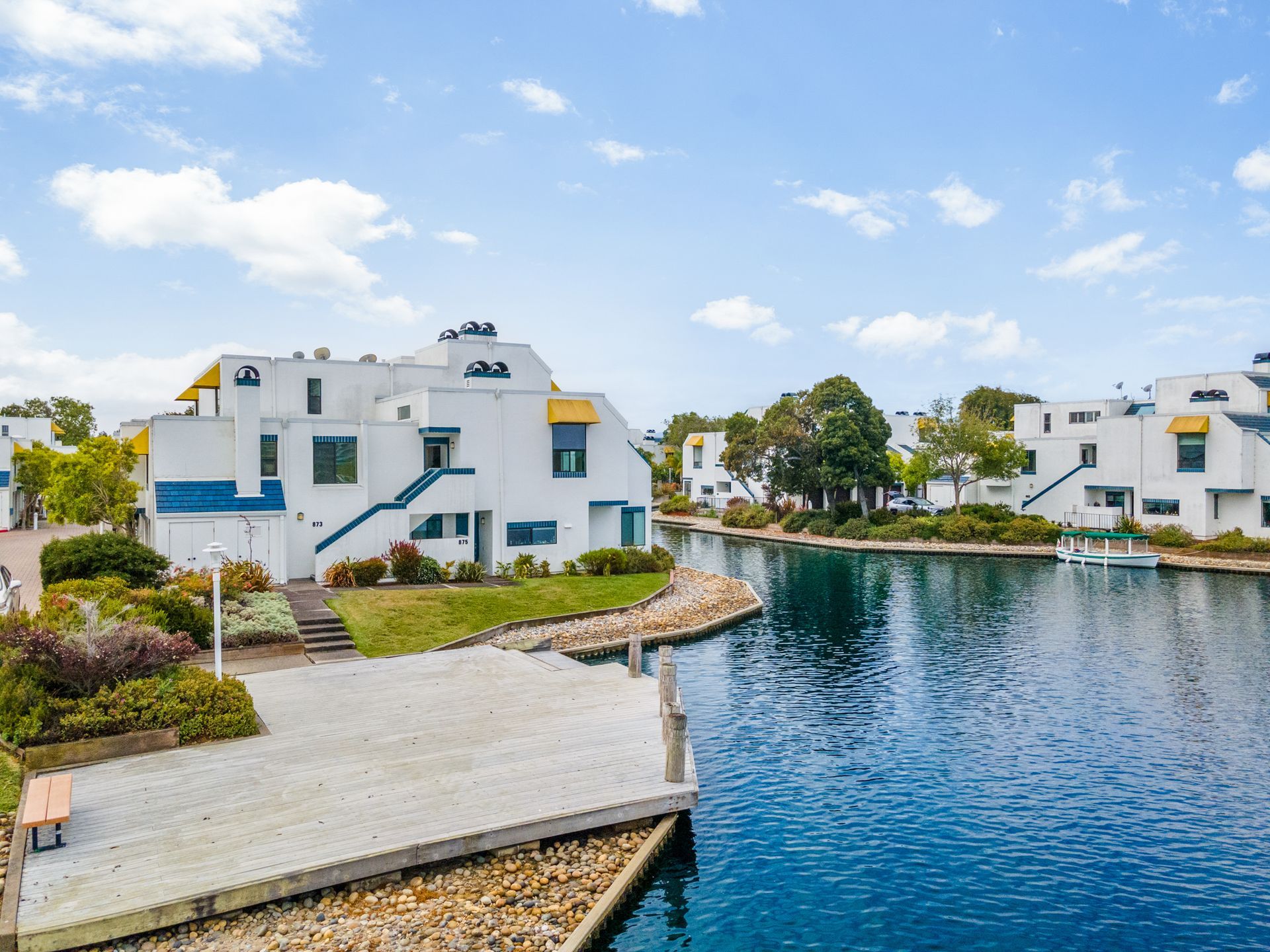 A group of buildings sitting next to a body of water.