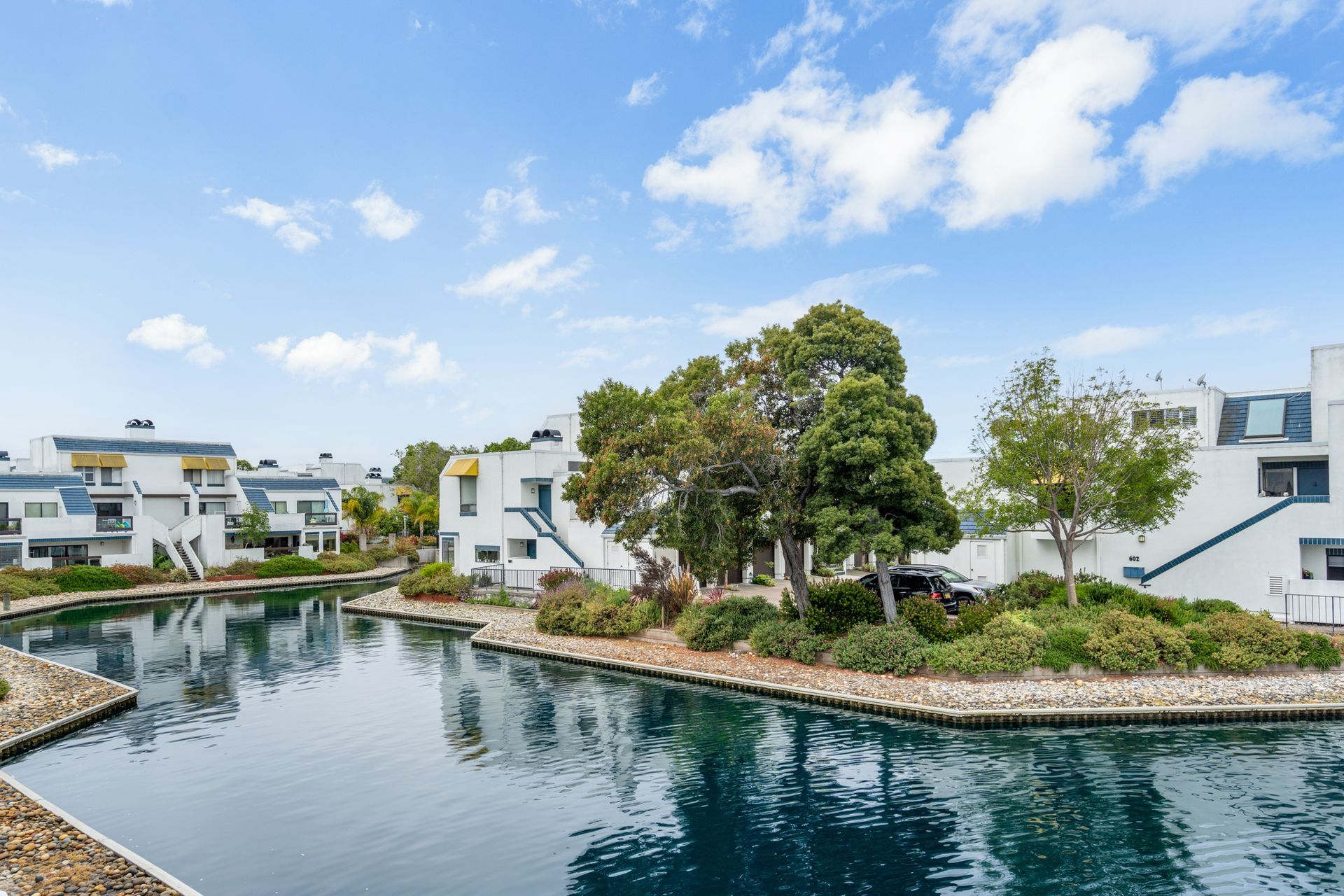A large body of water surrounded by buildings and trees.