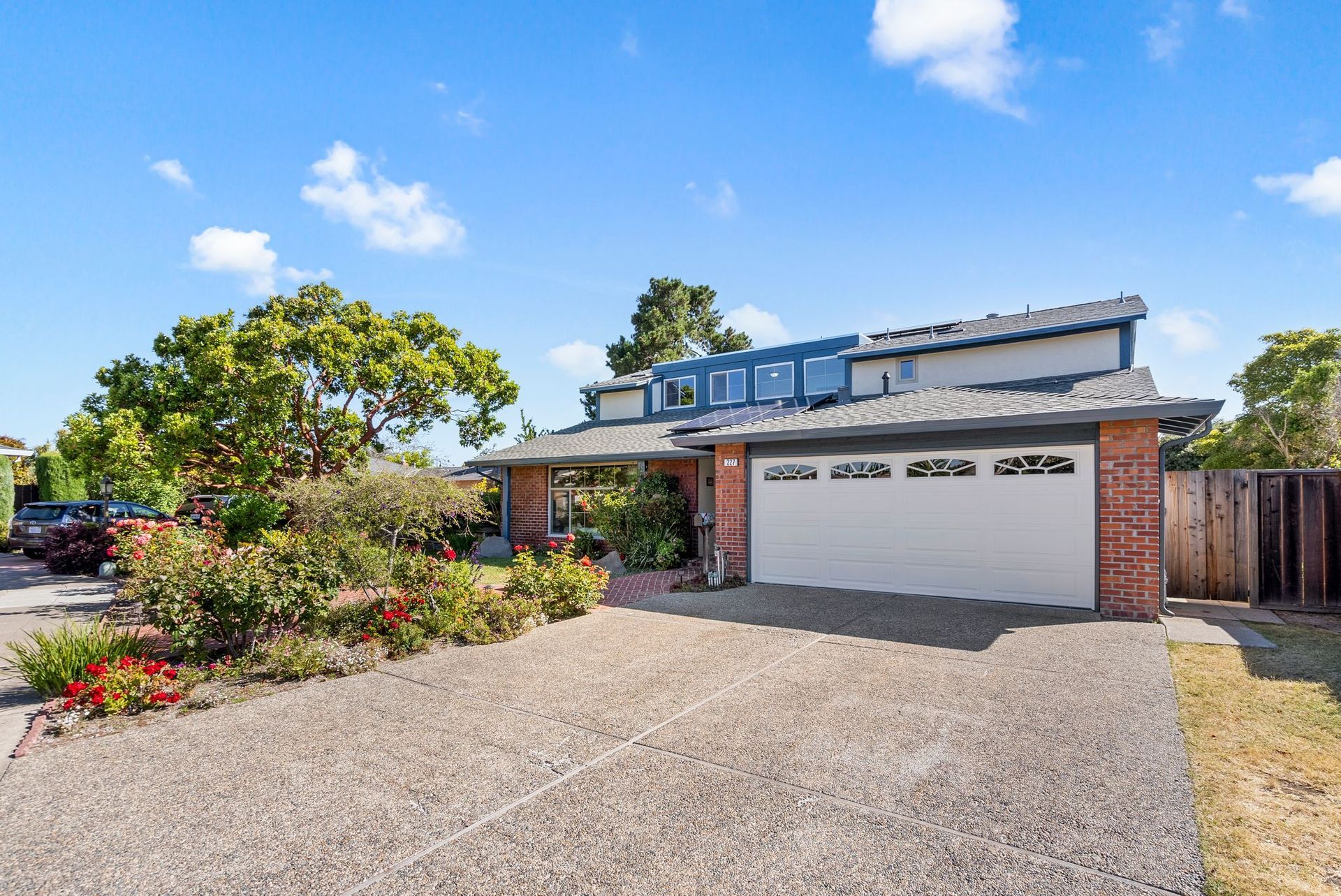 A house with a garage and a driveway in front of it