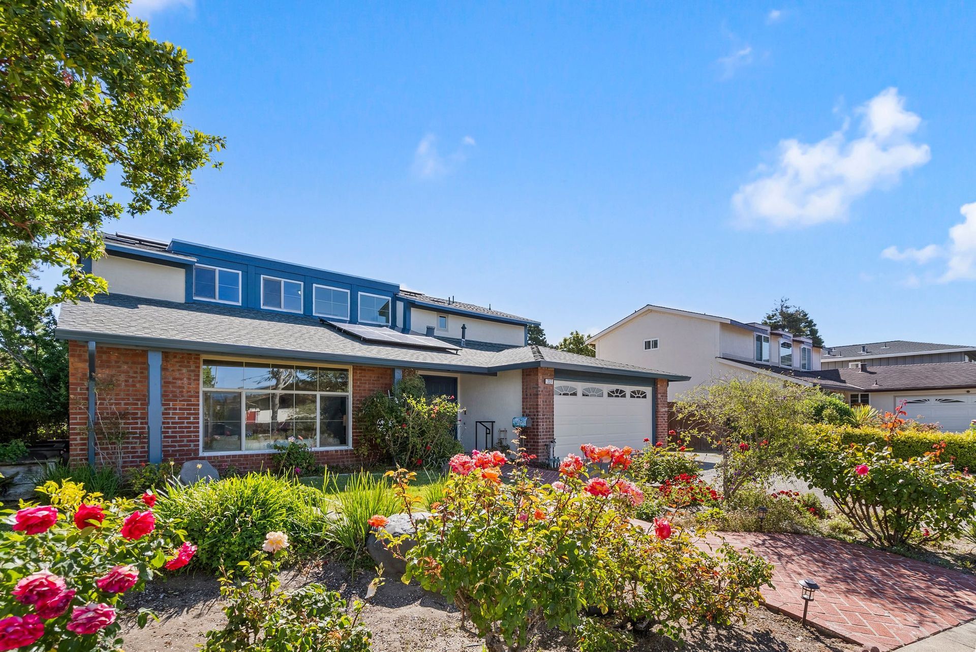A house with a lot of flowers in front of it