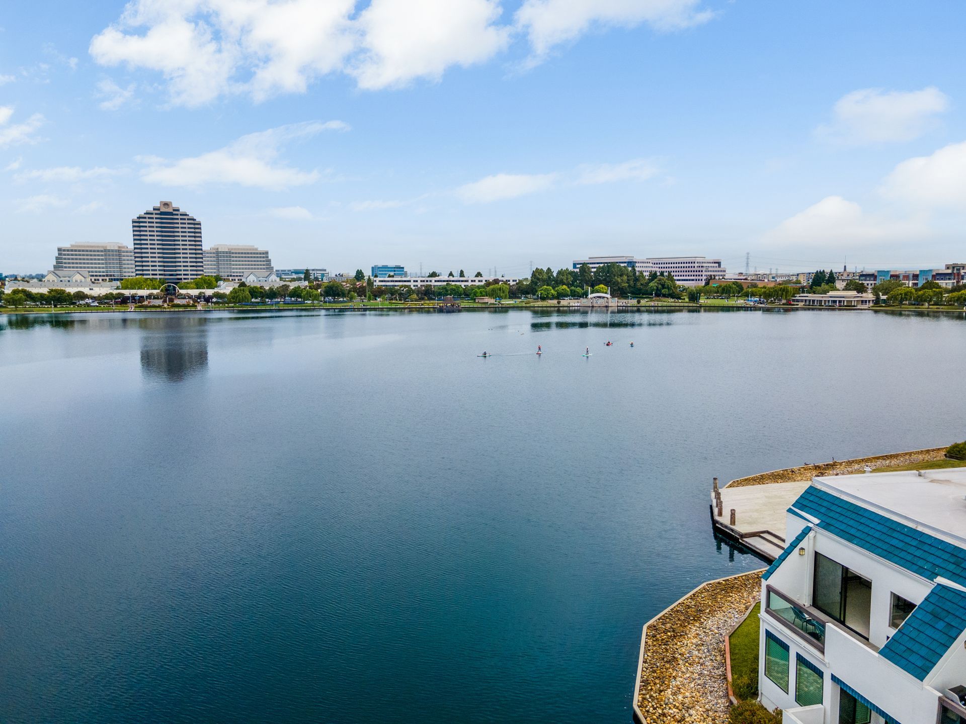 An aerial view of a large body of water with a house in the foreground.