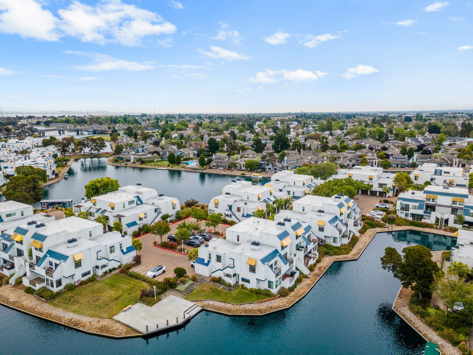 An aerial view of a residential area surrounded by water and buildings.