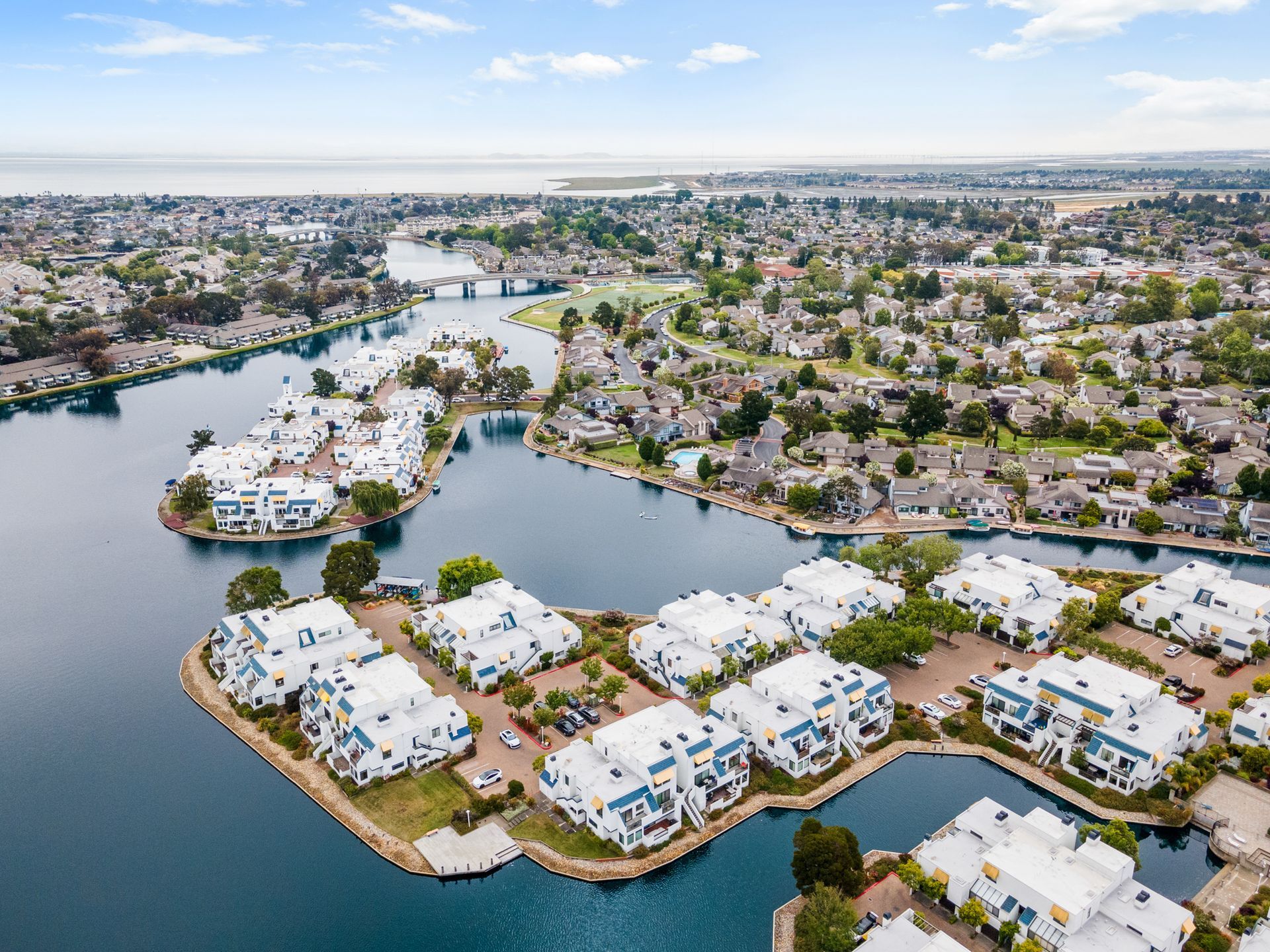 An aerial view of a residential area surrounded by water and buildings.
