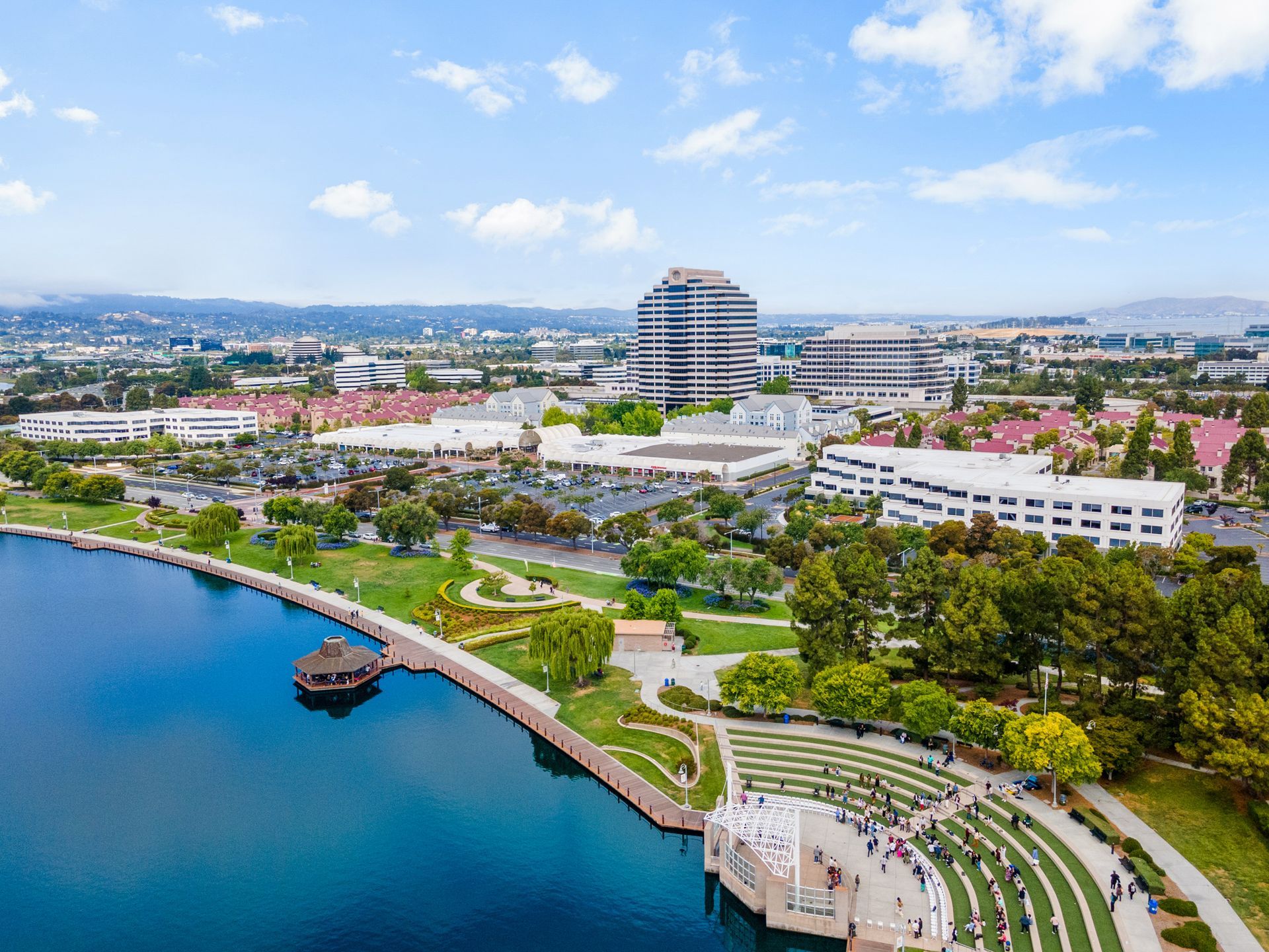 An aerial view of a lake surrounded by buildings and trees.