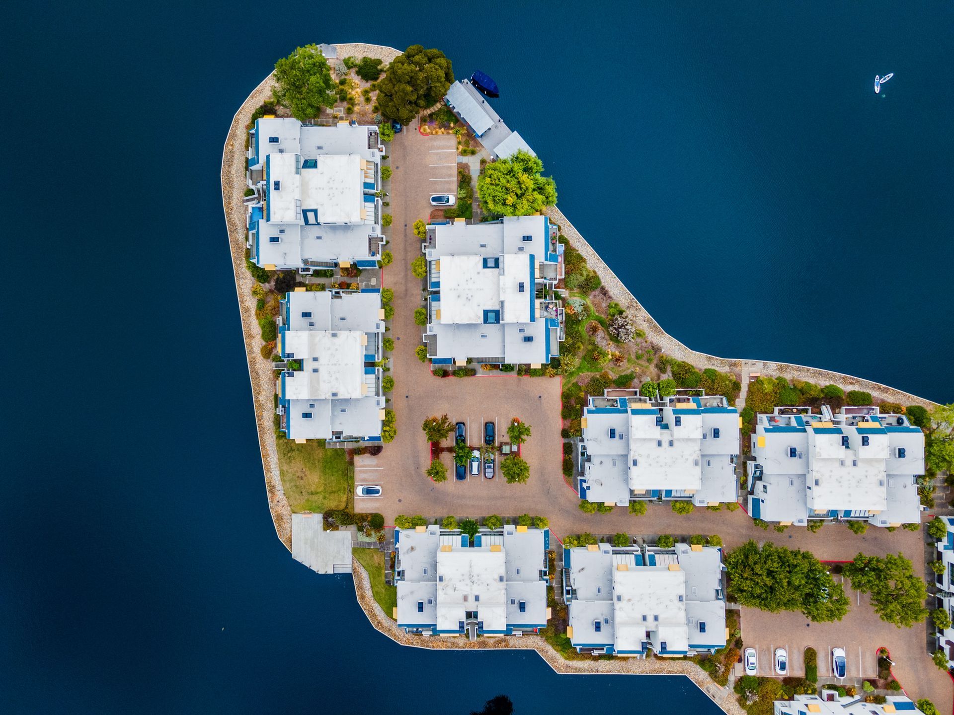 An aerial view of a residential area on a small island in the middle of a body of water.