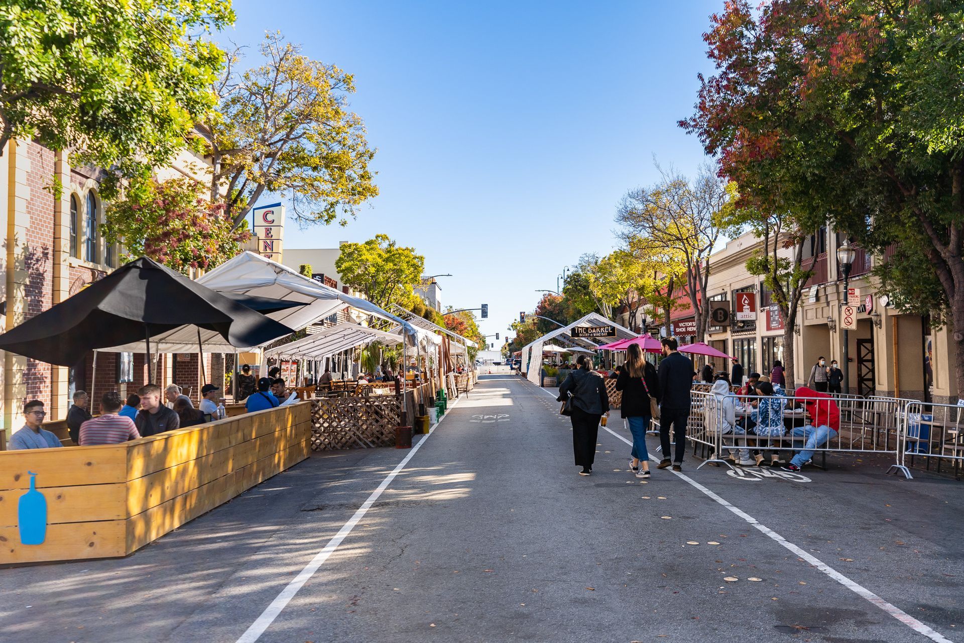 A group of people are walking down a city street.
