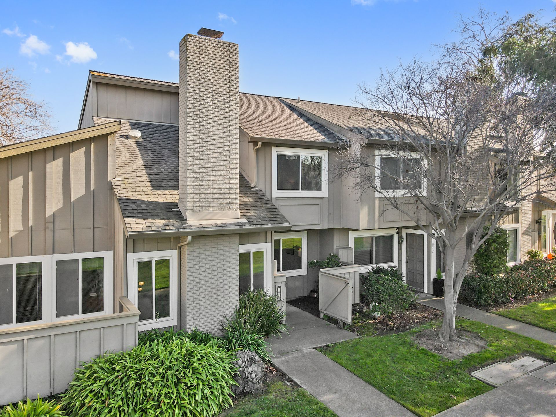 A house with a chimney and a lot of windows