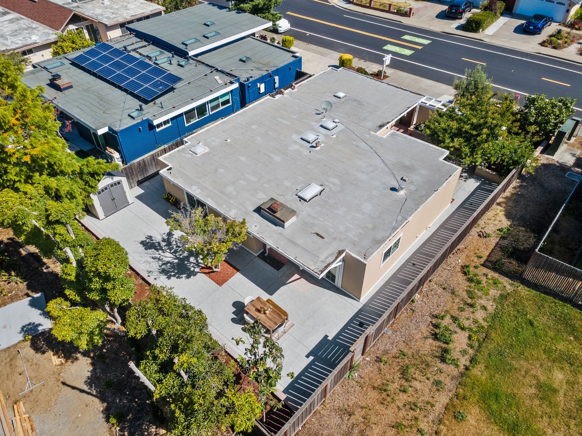 An aerial view of a house with solar panels on the roof