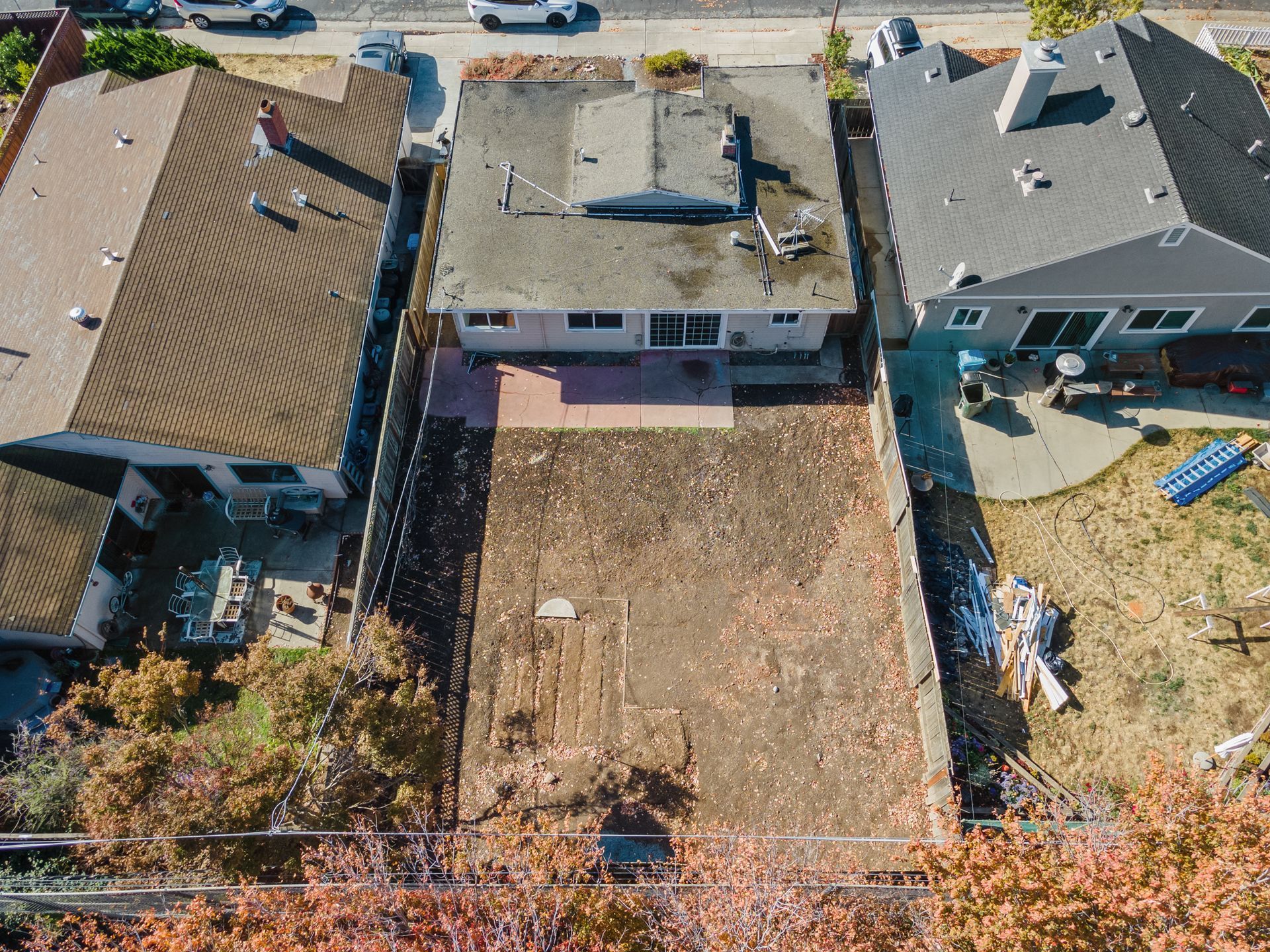 An aerial view of a house with a lot of dirt in front of it