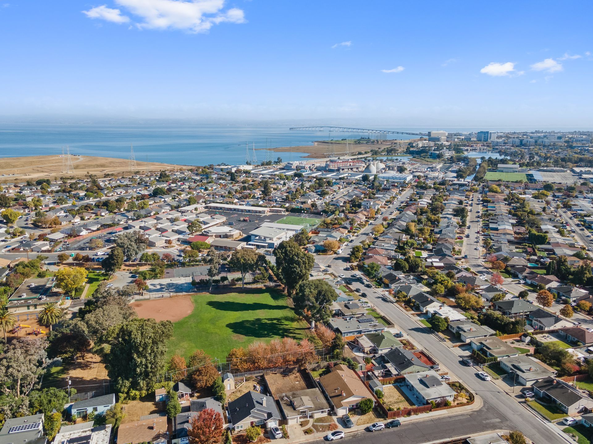 An aerial view of a residential area next to the ocean.