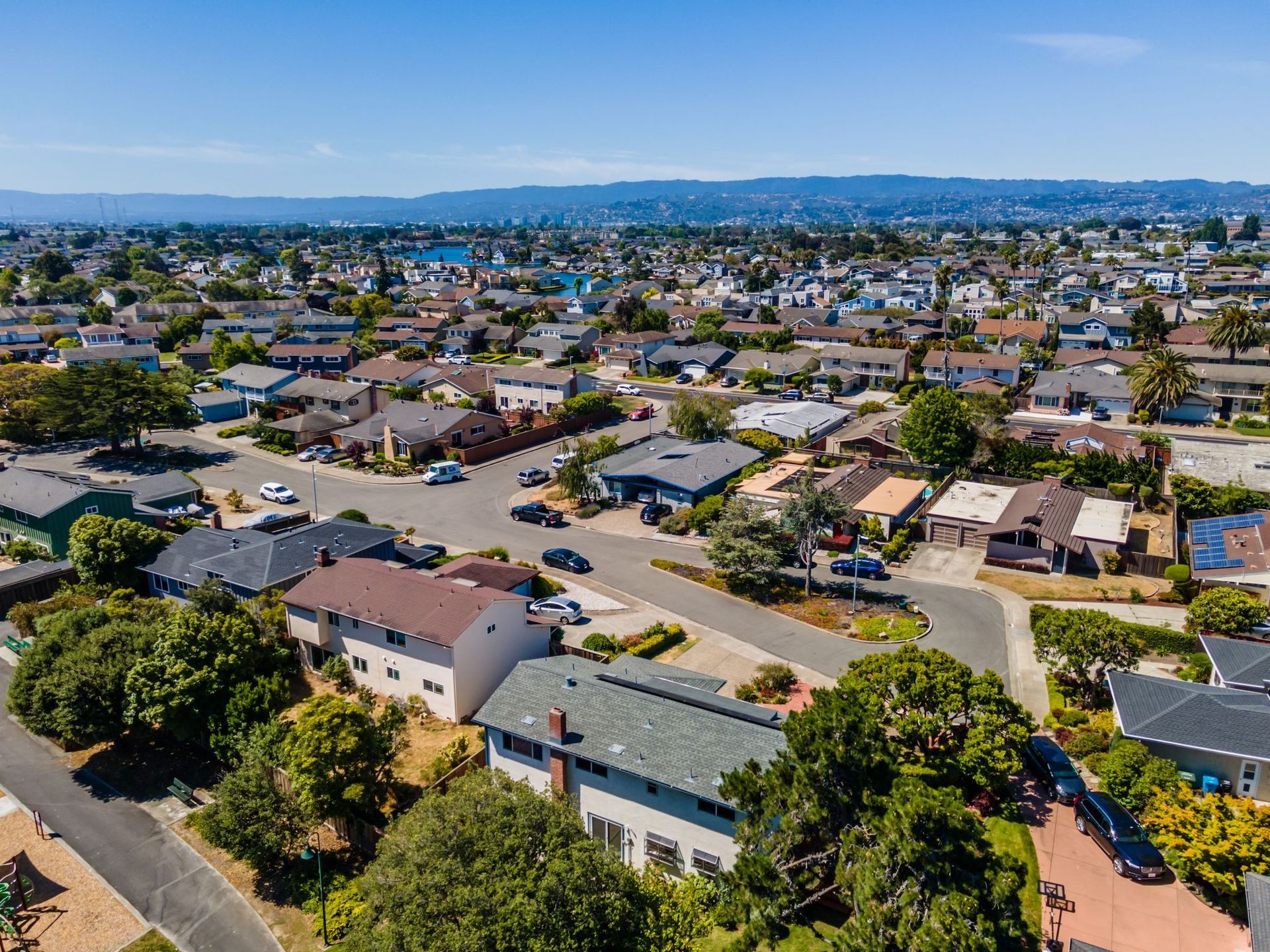 An aerial view of a residential area with lots of houses and trees.