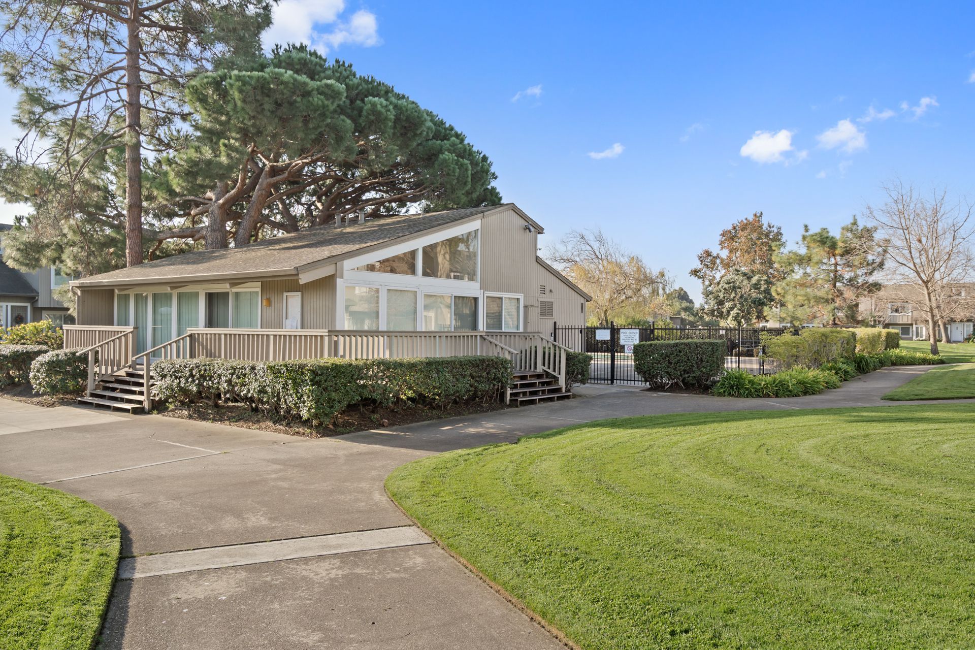 A house with a large lawn in front of it