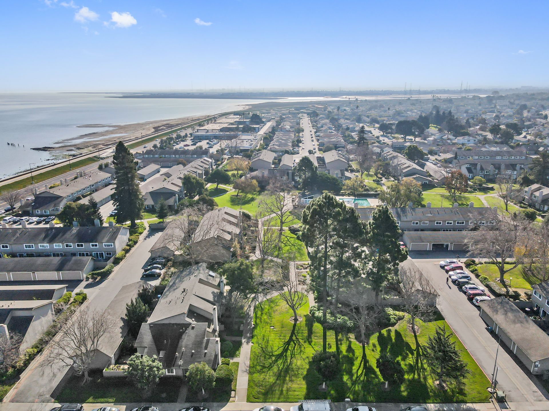An aerial view of a city with a large body of water in the background