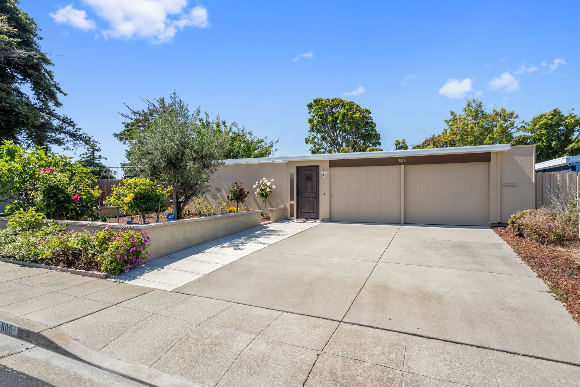 A house with a concrete driveway leading to it
