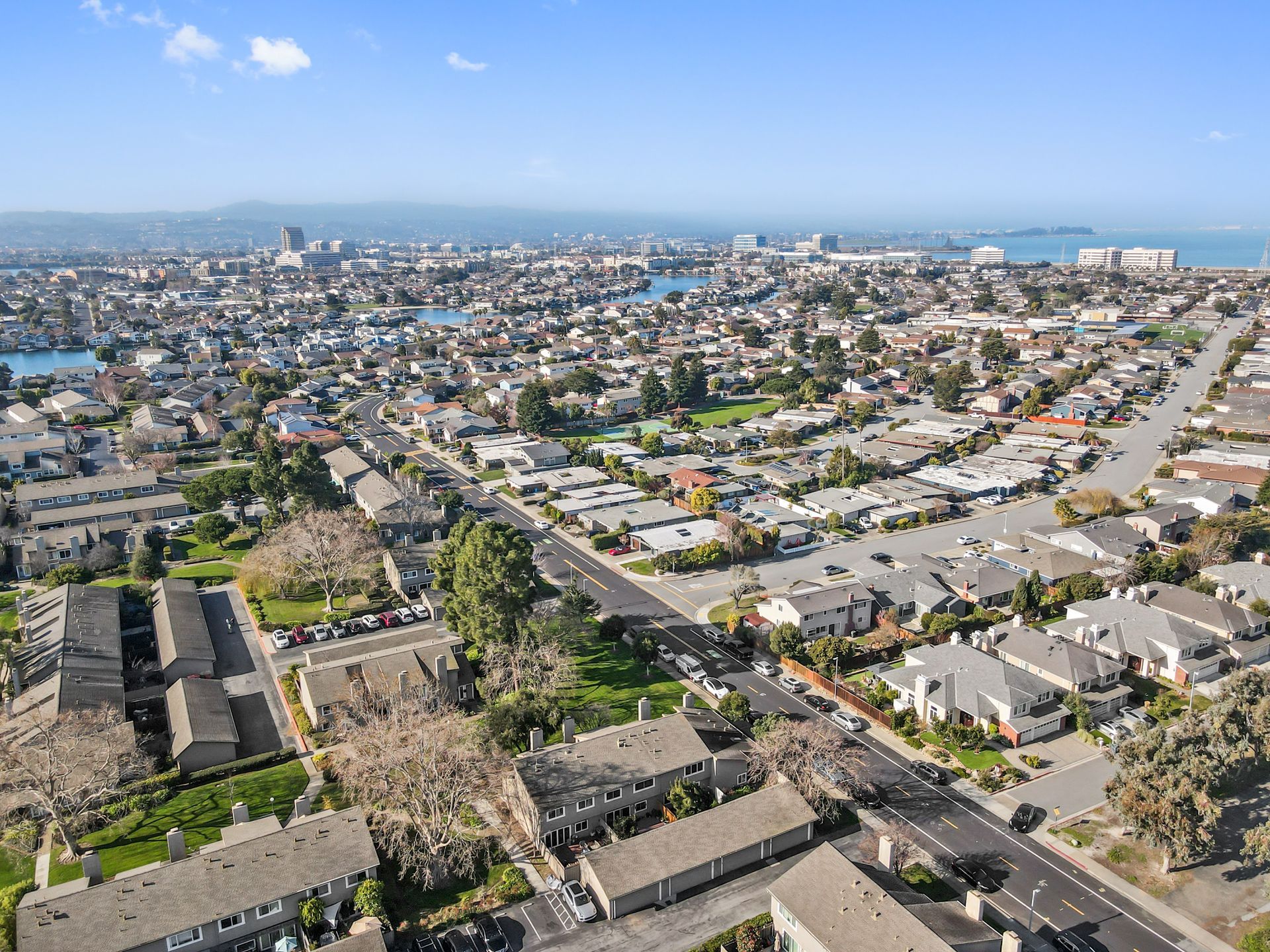 An aerial view of a residential area with a city in the background.