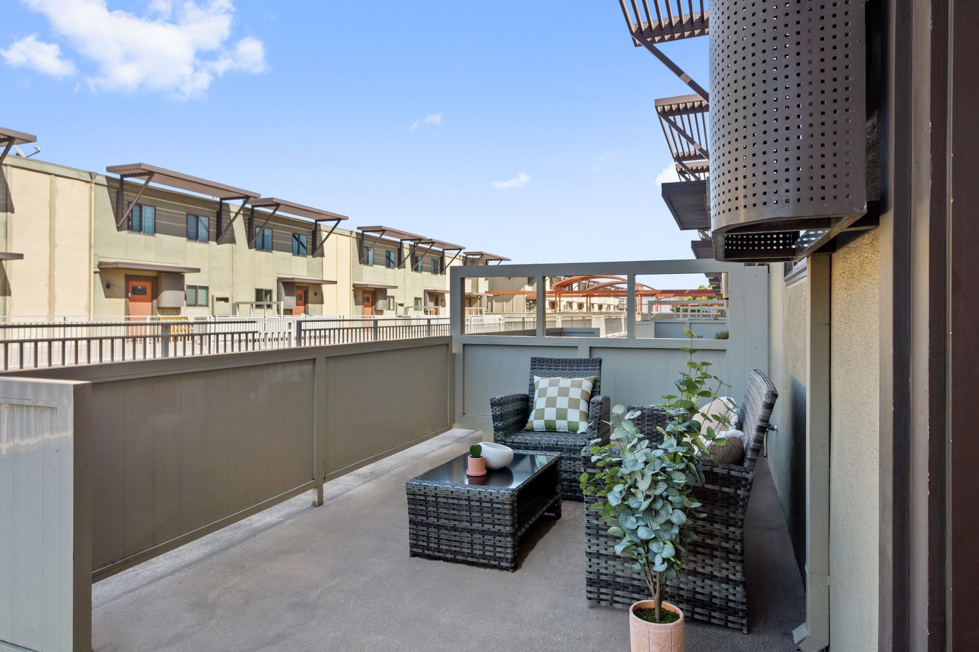 There is a balcony with a couch and a table on it.
