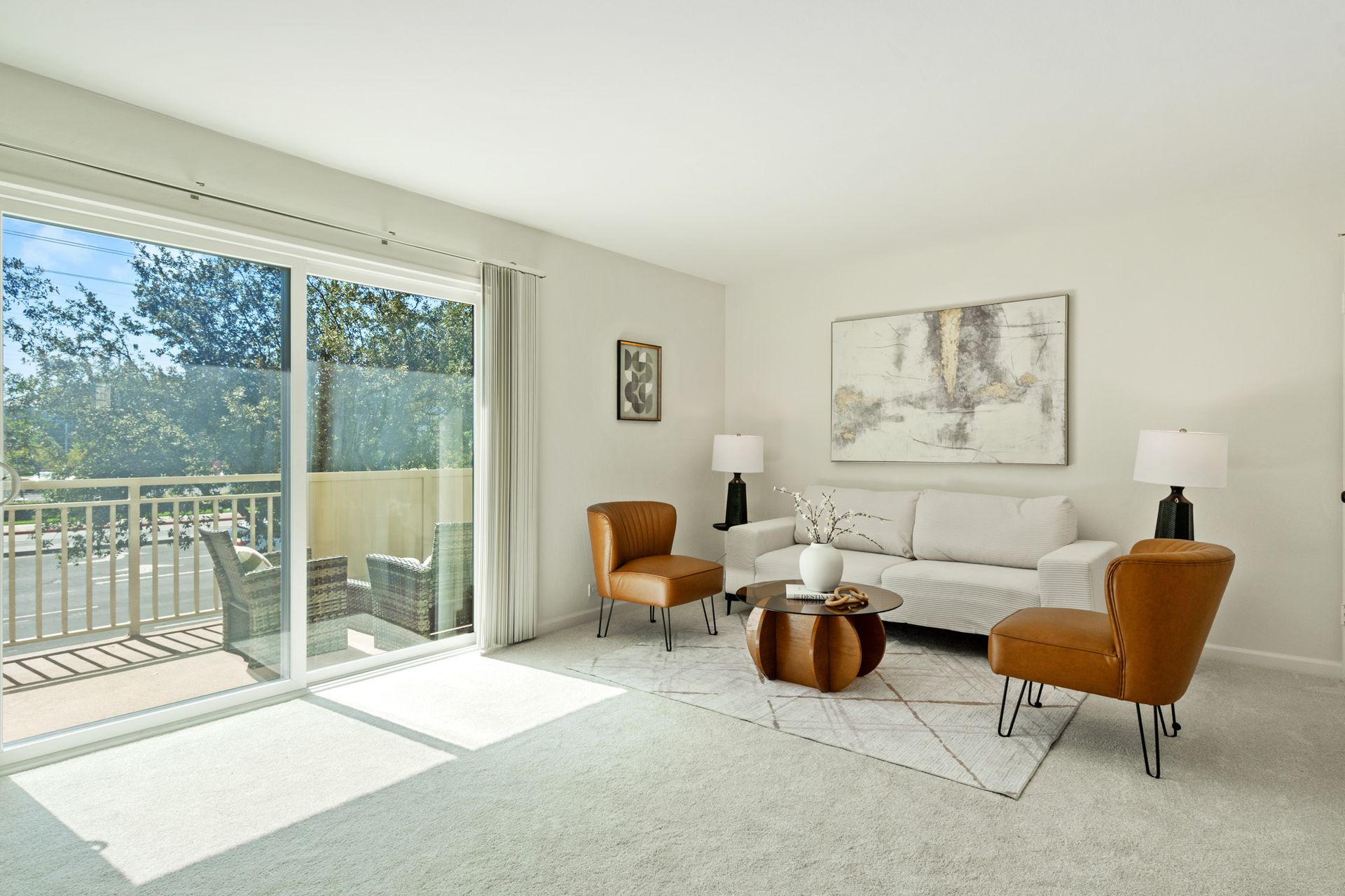 A living room with a couch , chairs and a table