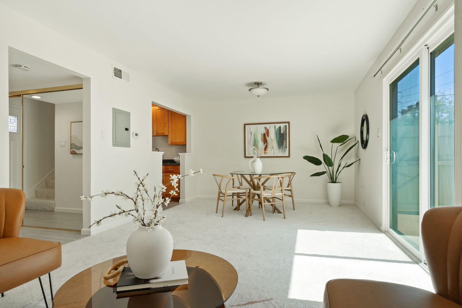 A living room with a table and chairs in it