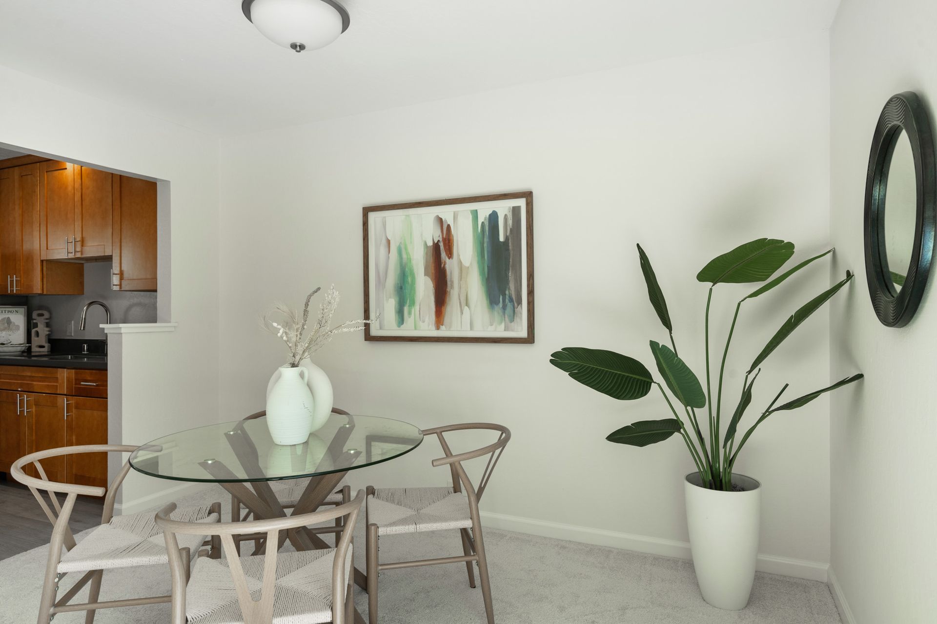 A dining room with a glass table and chairs