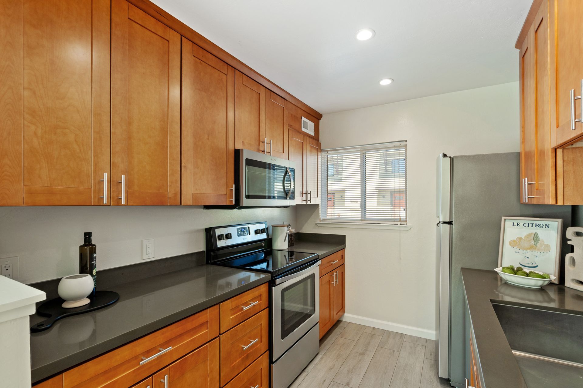 A kitchen with stainless steel appliances and wooden cabinets