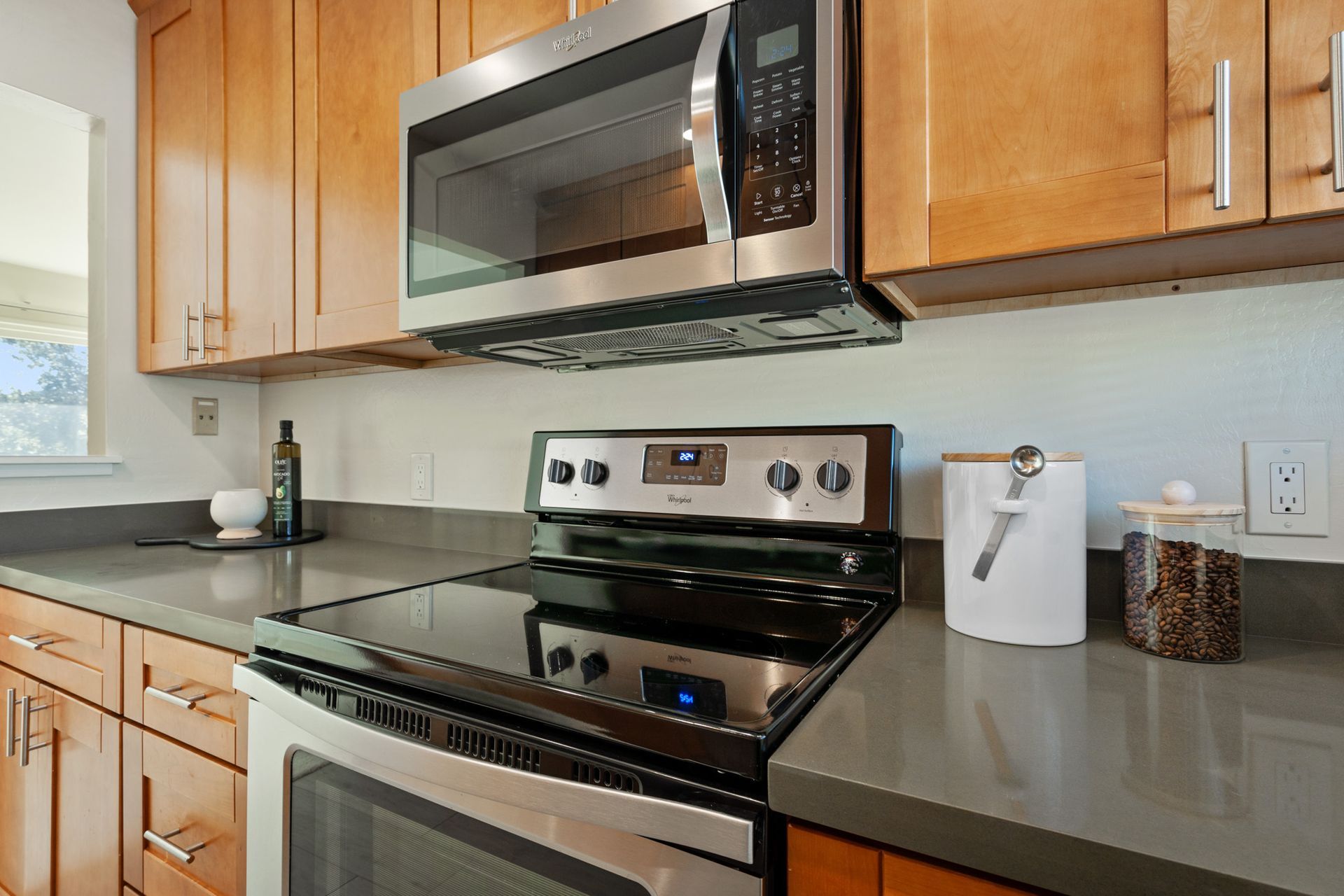 A kitchen with stainless steel appliances and wooden cabinets