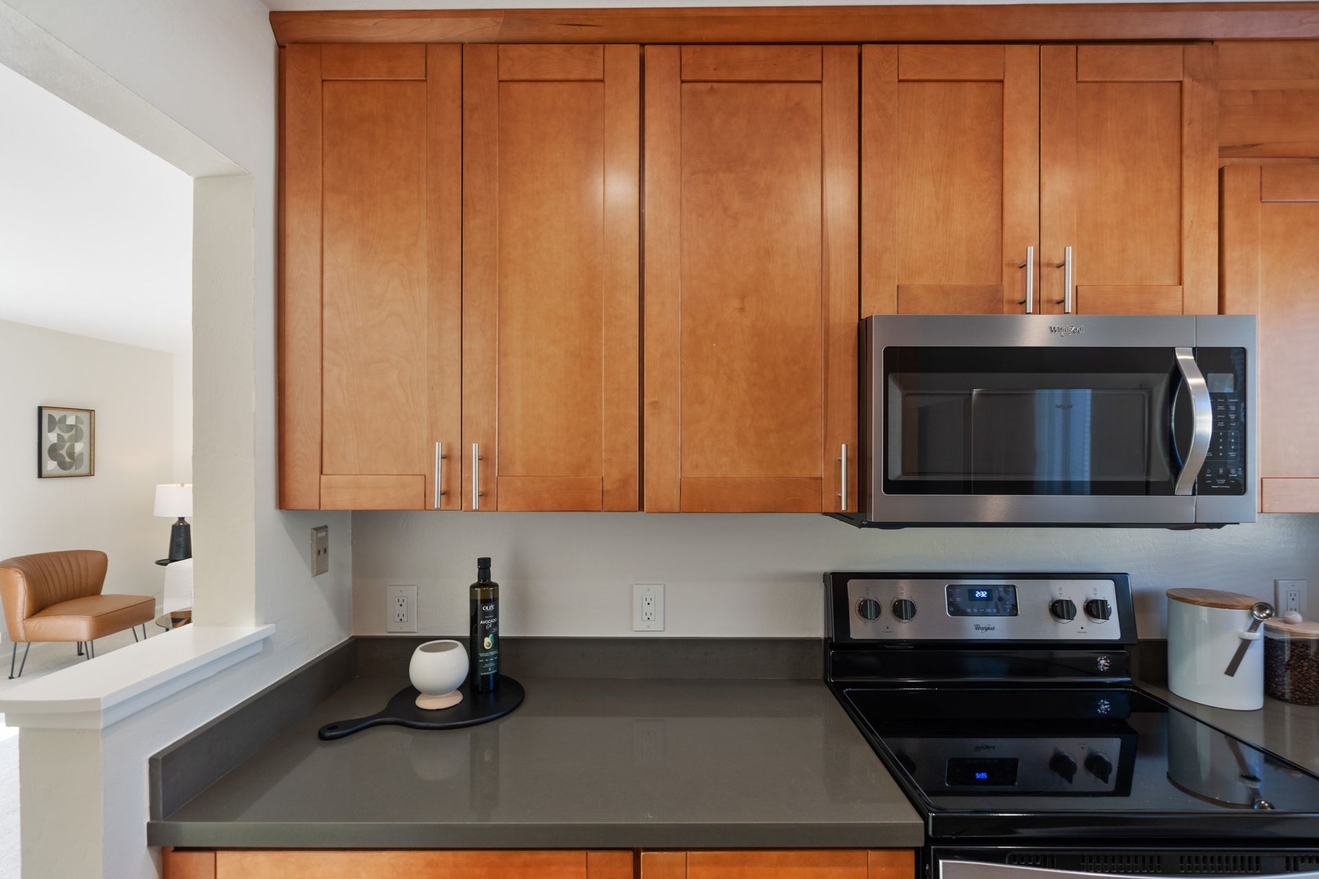 A kitchen with stainless steel appliances and wooden cabinets