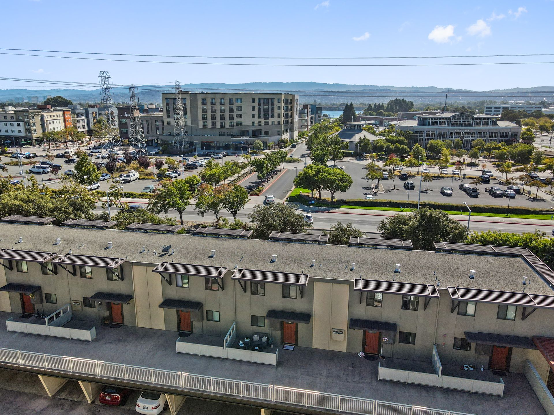 An aerial view of a building with a lot of cars parked in front of it