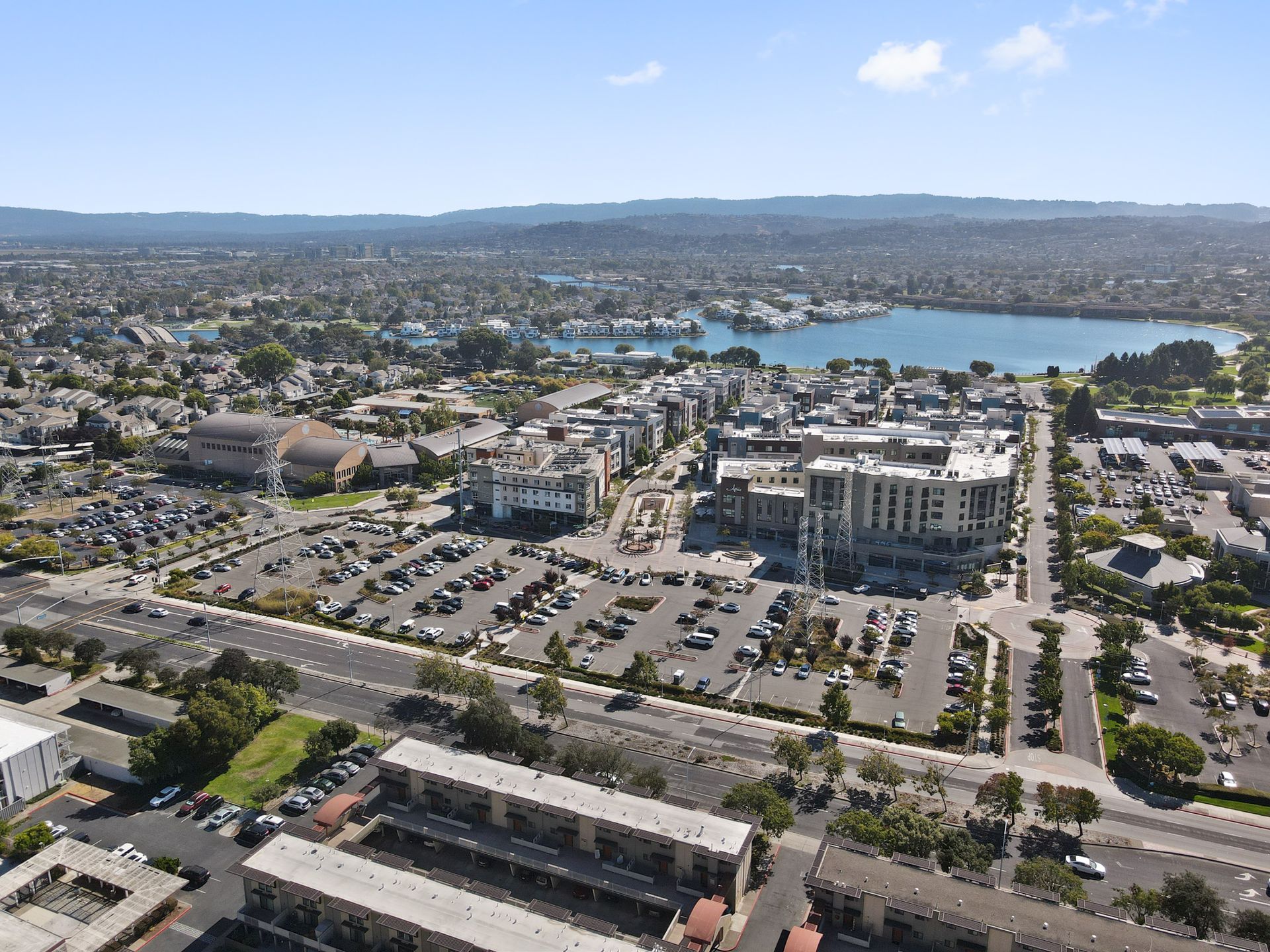An aerial view of a city with a lake in the background.