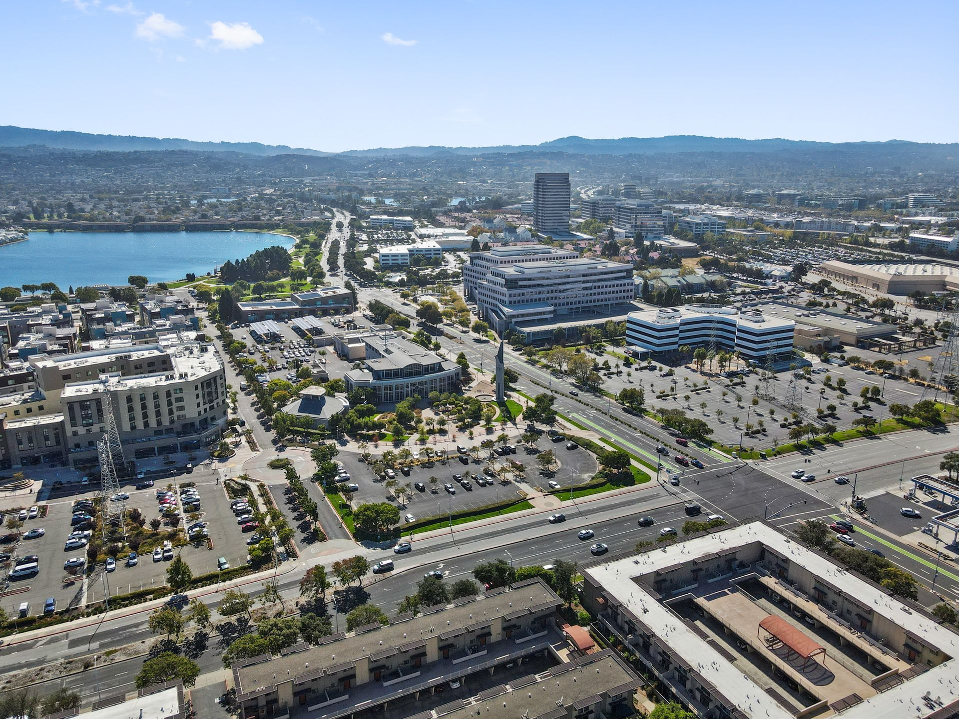 An aerial view of a city with a lake in the background.