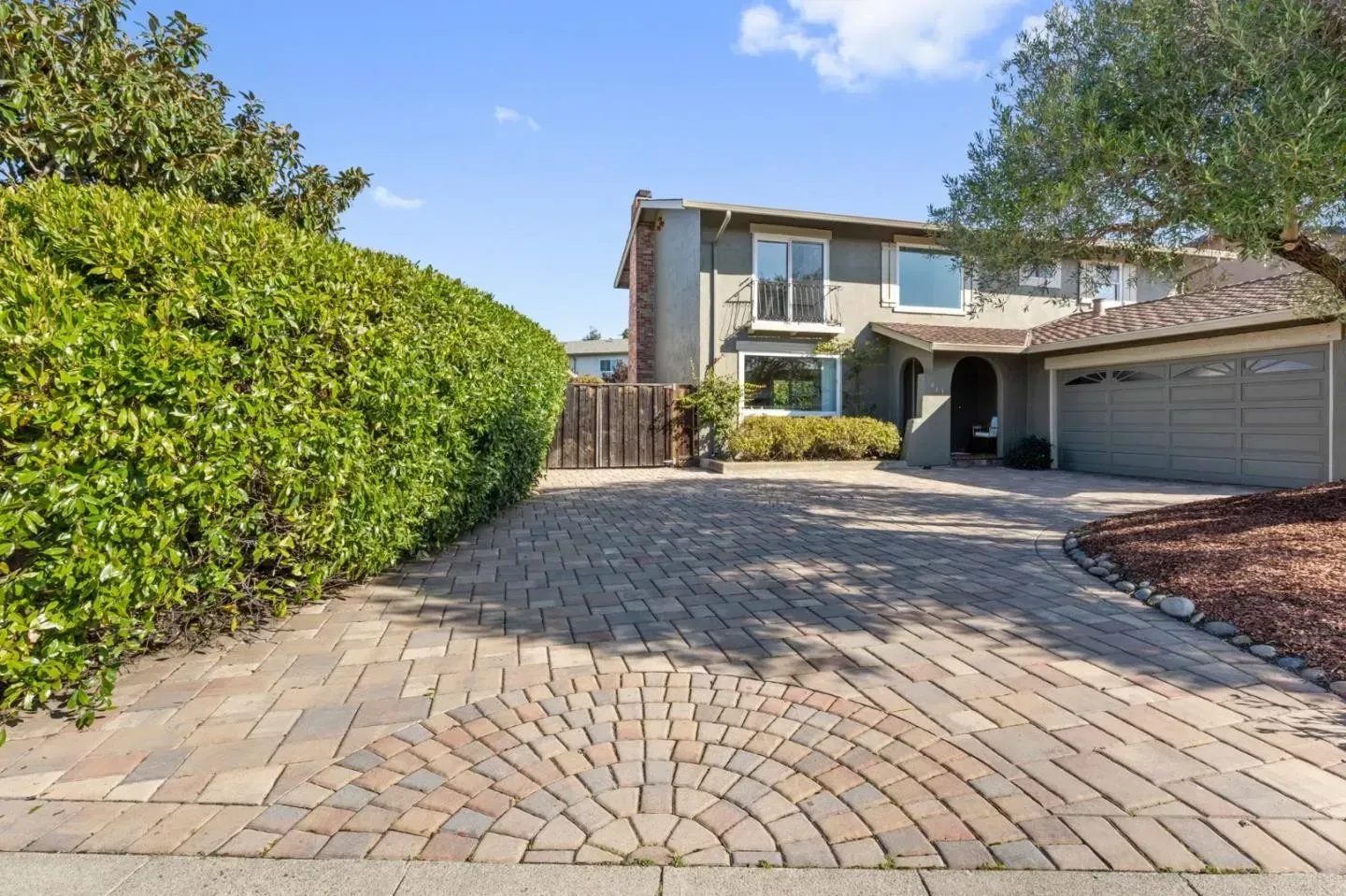 A house with a brick driveway leading to it