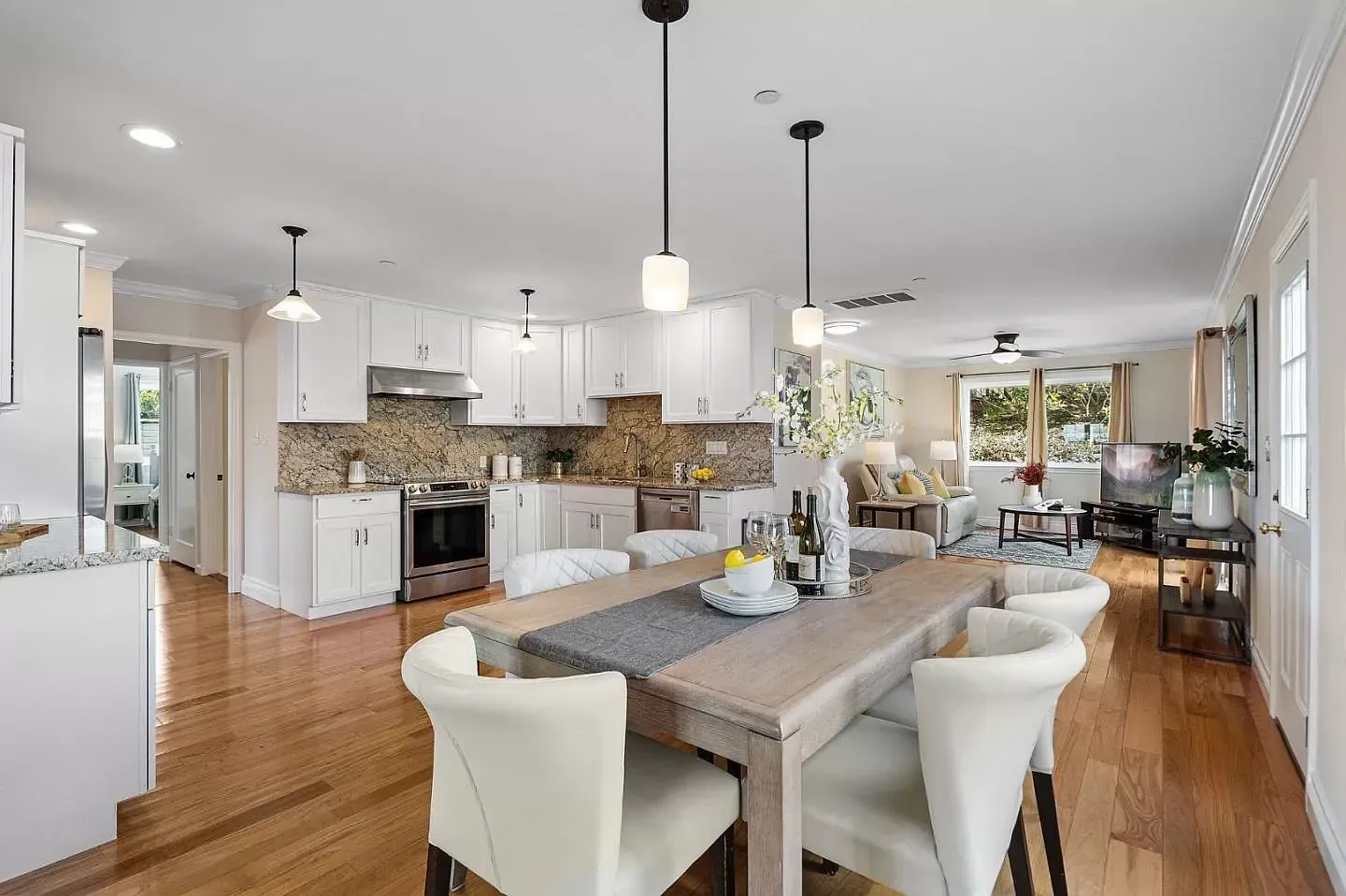 There is a dining table and chairs in the middle of the room.