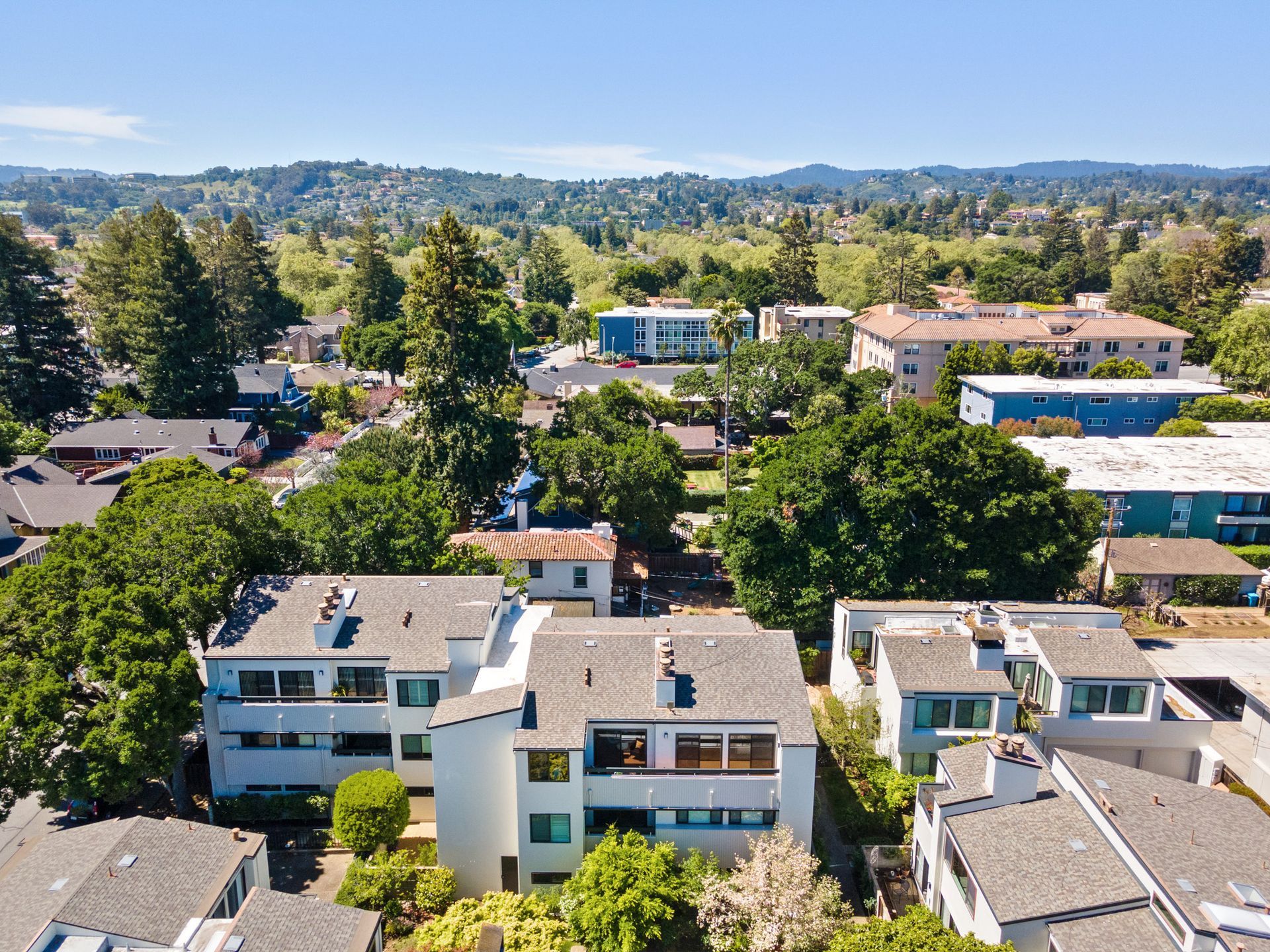 An aerial view of a residential area with trees and buildings