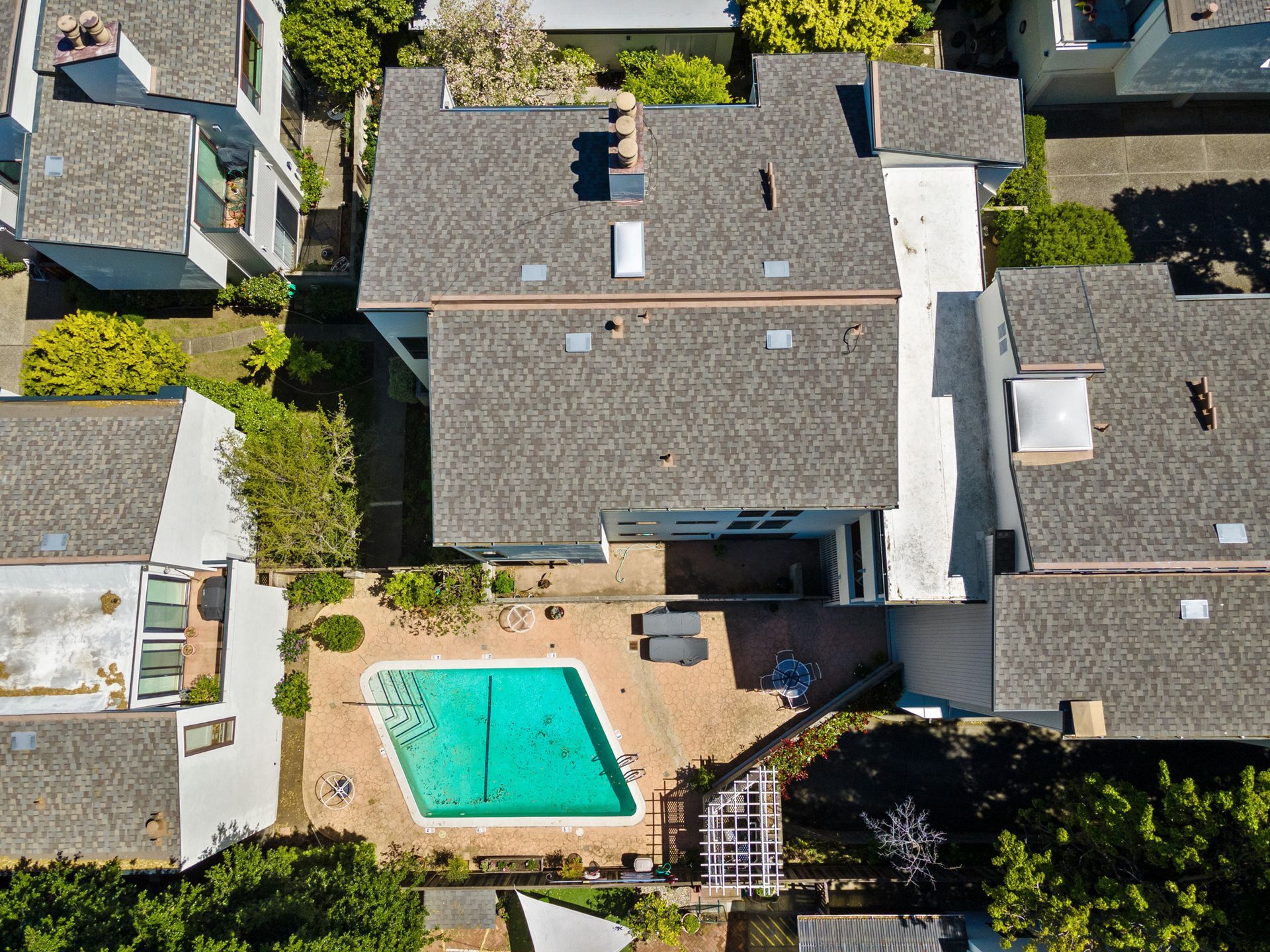 An aerial view of a house with a pool in the backyard