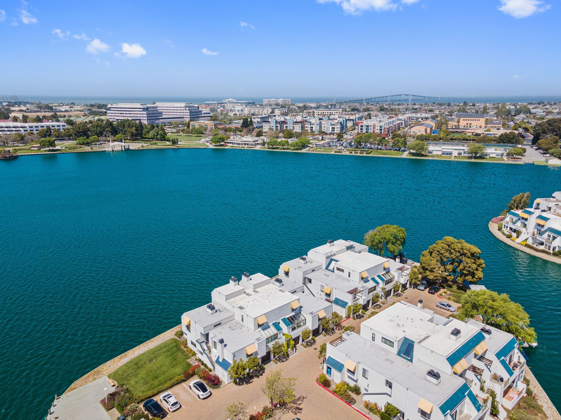An aerial view of a lake with buildings on the shore
