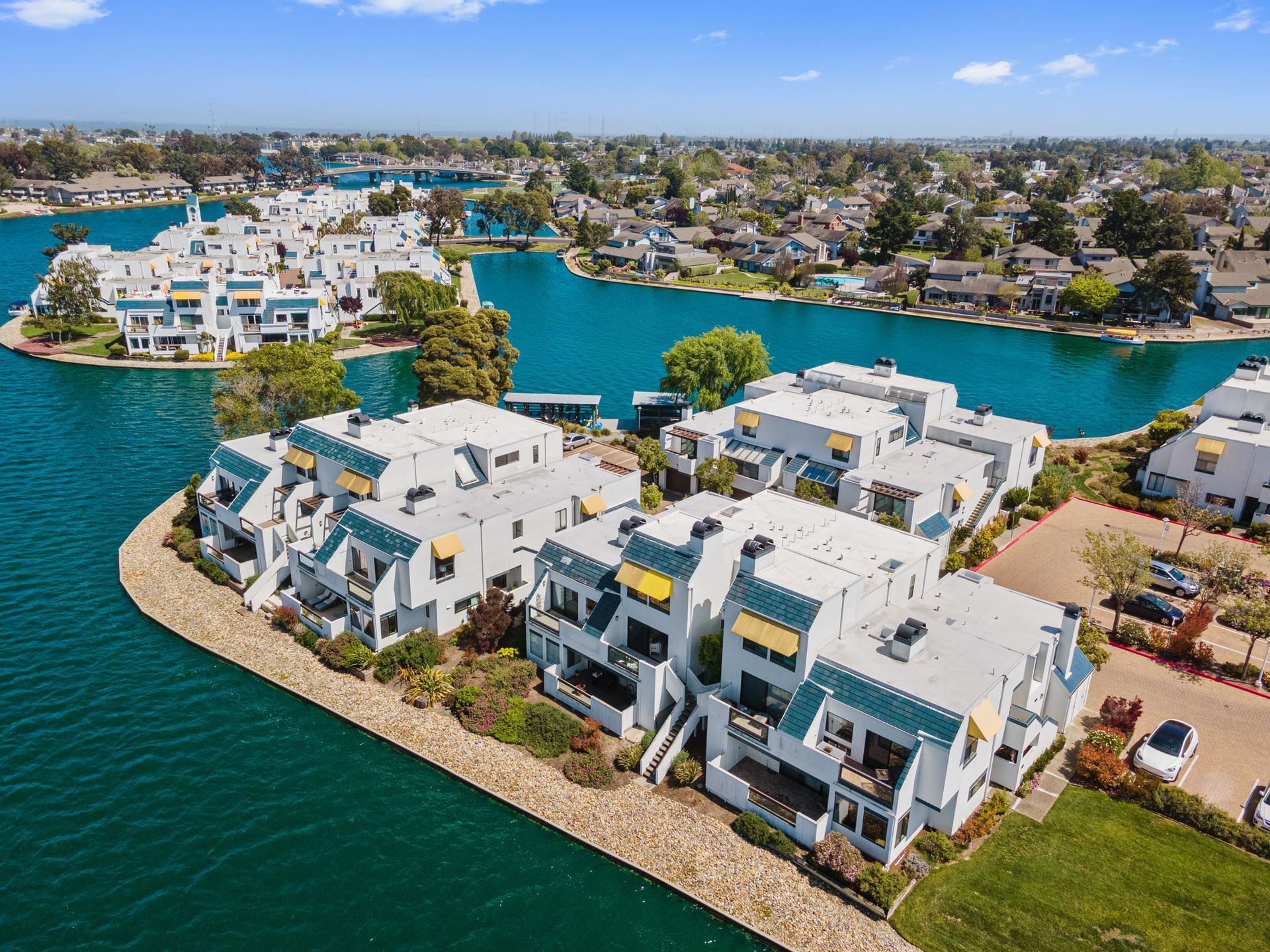 An aerial view of a residential area surrounded by water and buildings.