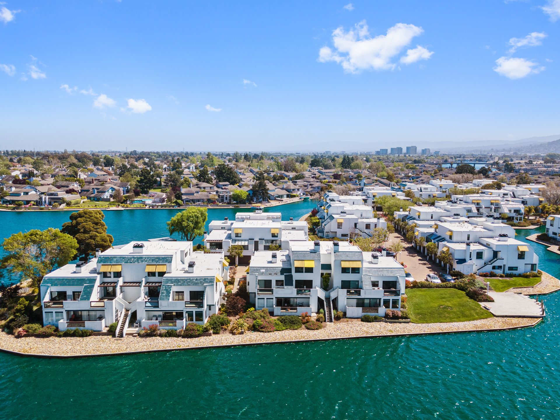 An aerial view of a residential area next to a body of water