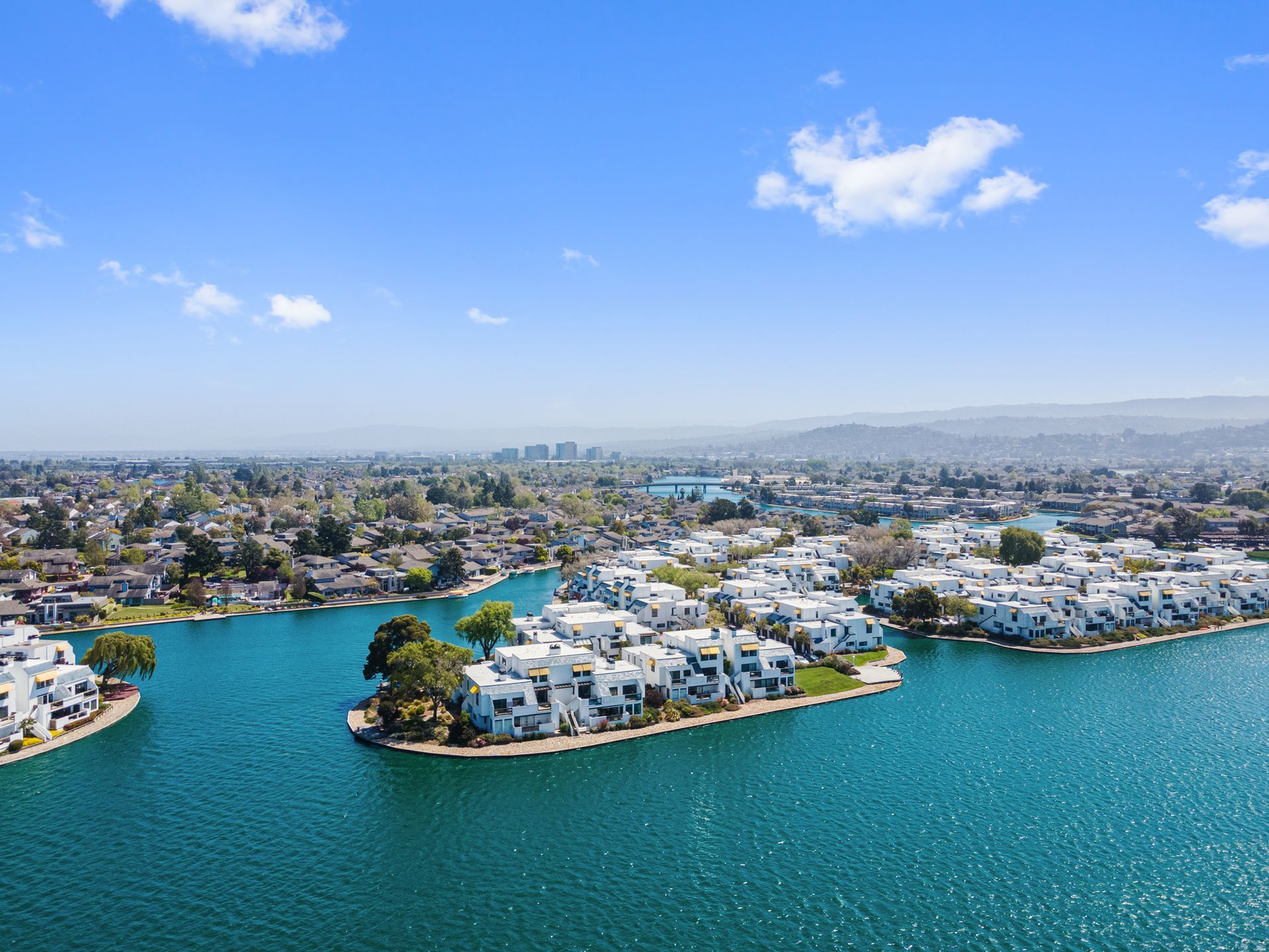 An aerial view of a lake with a small island in the middle.