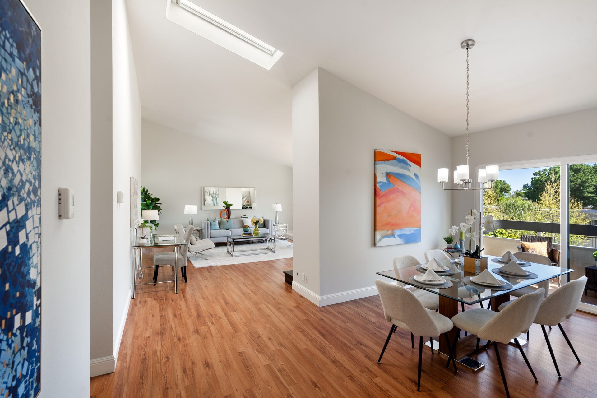 A living room and dining room in a house with hardwood floors.