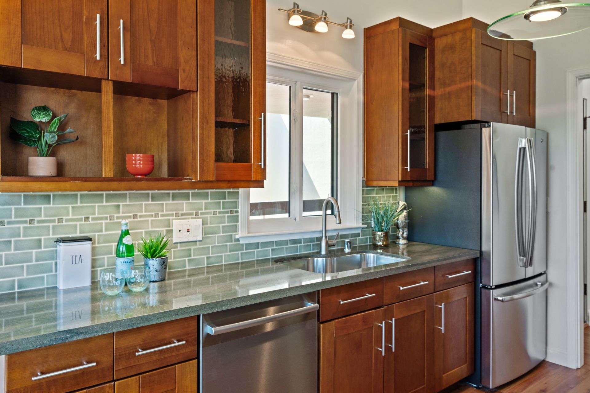 A kitchen with stainless steel appliances and wooden cabinets