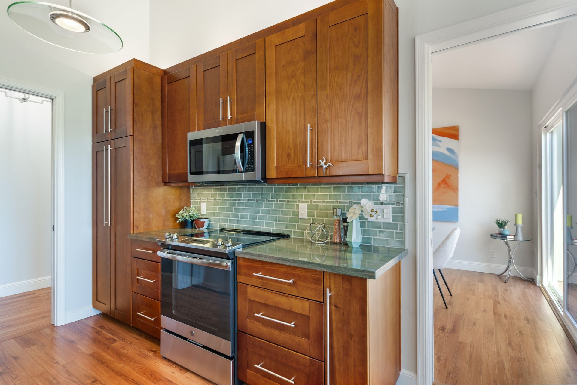 A kitchen with wooden cabinets and stainless steel appliances