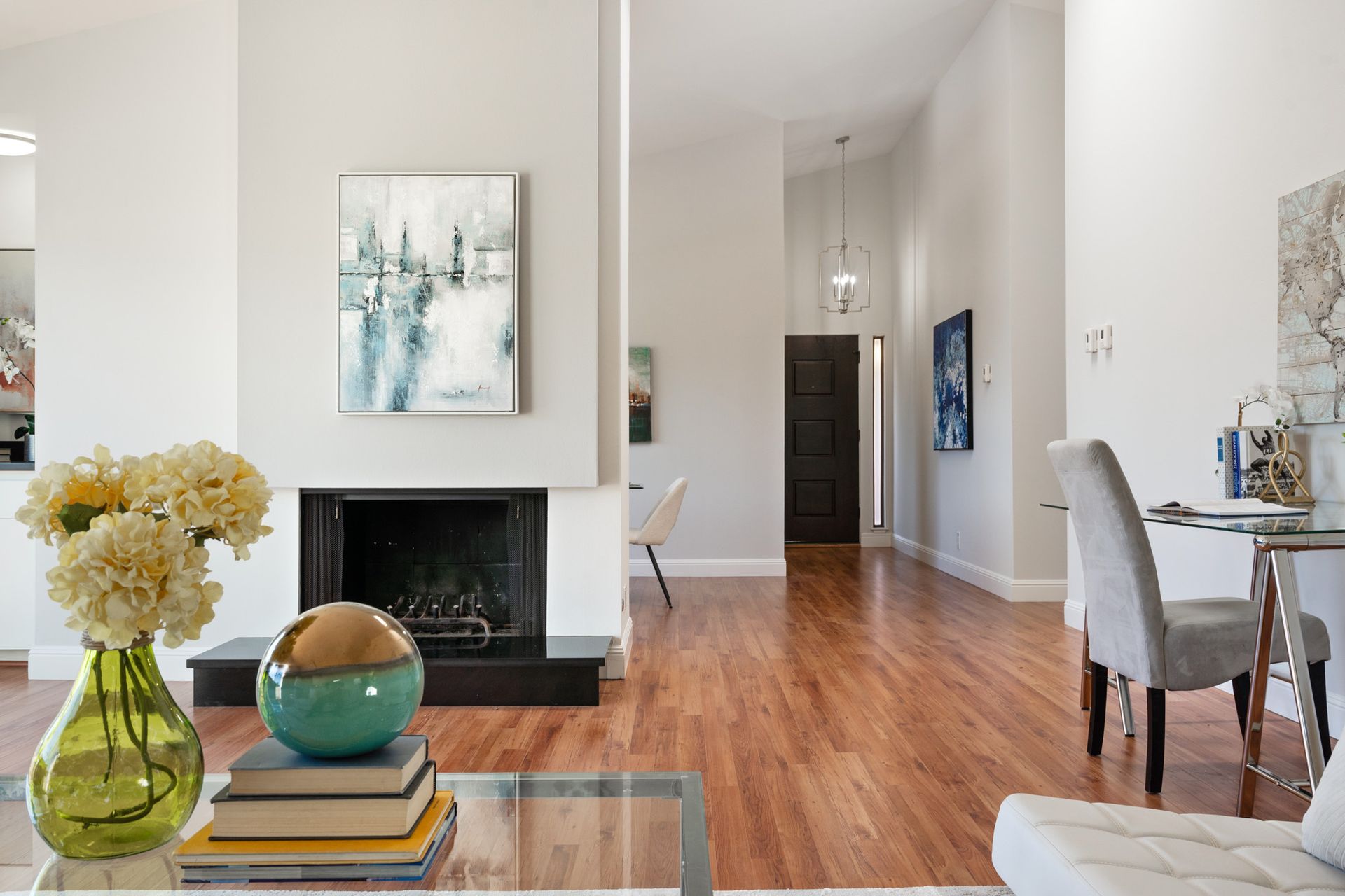 A living room with hardwood floors and a fireplace