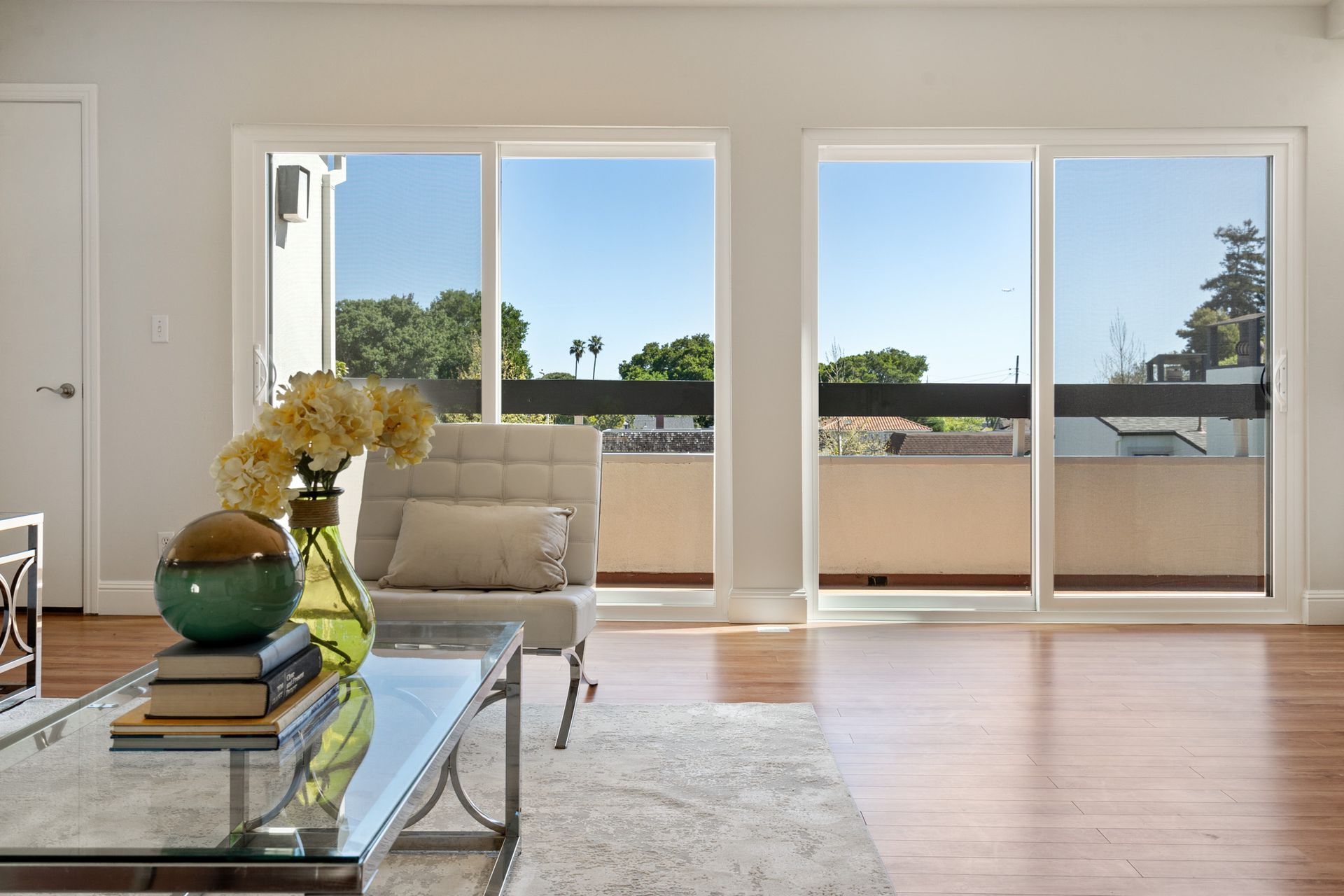 A living room with sliding glass doors leading to a balcony