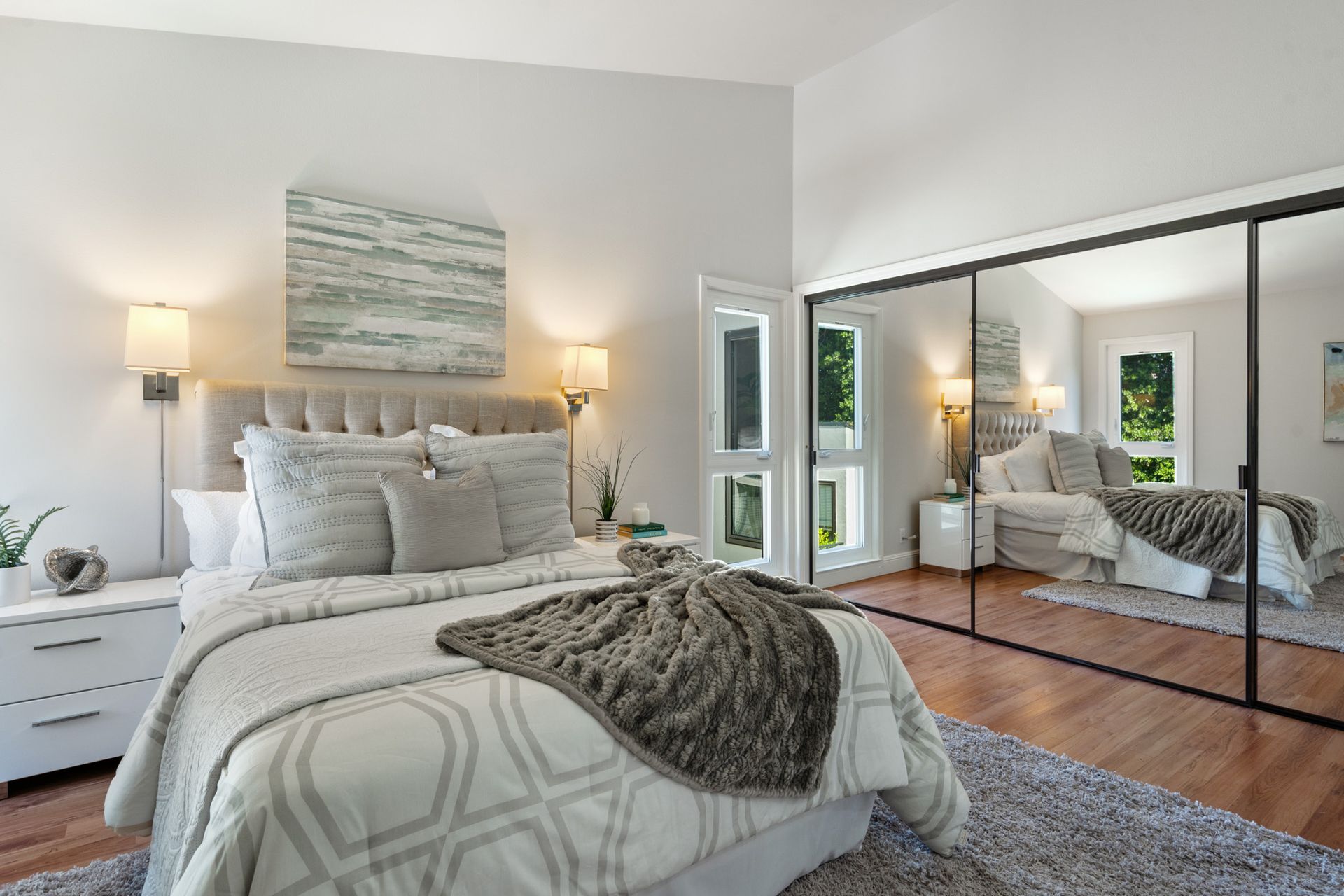 A bedroom with a large bed and sliding glass doors.