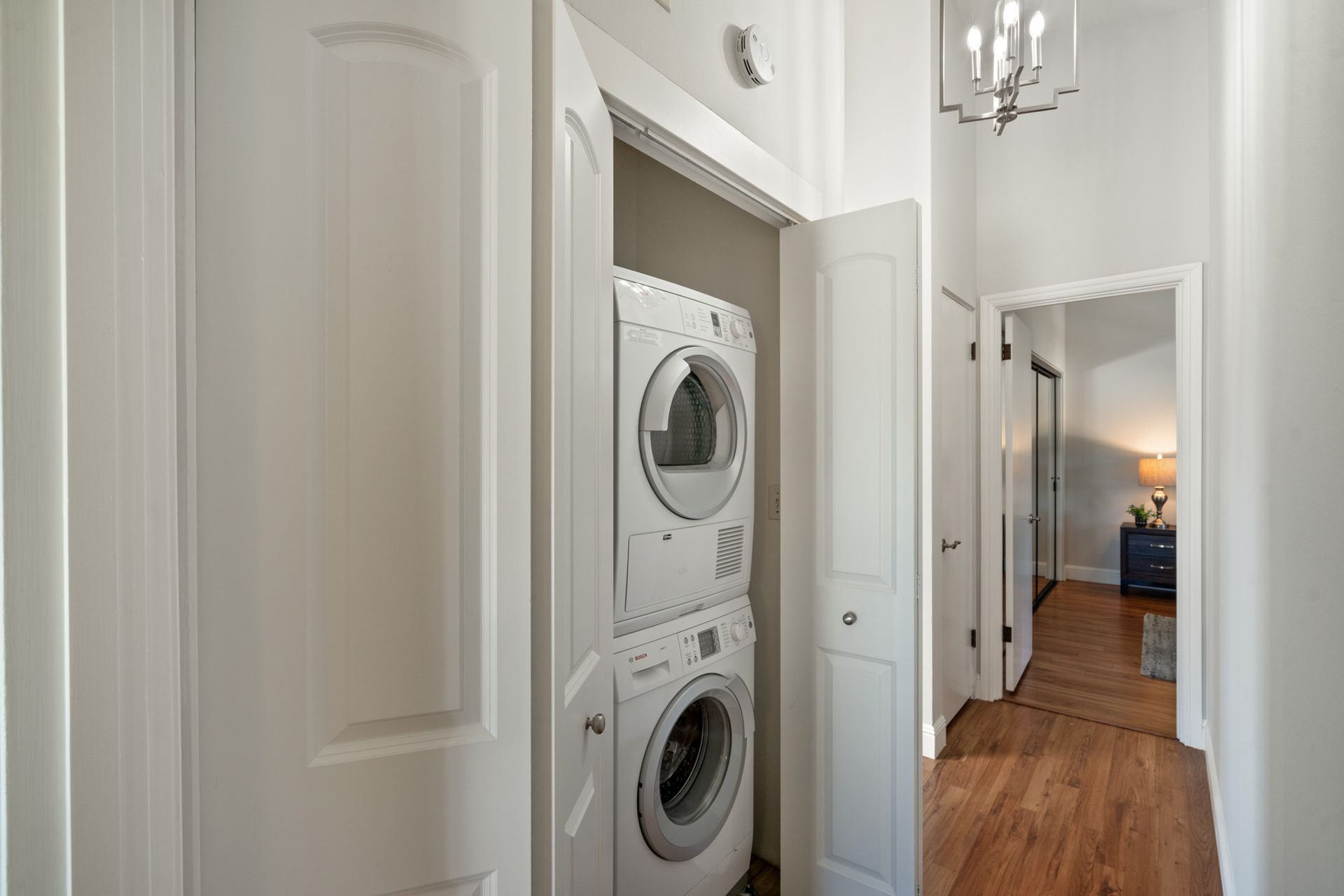 A washer and dryer are stacked on top of each other in a laundry room.