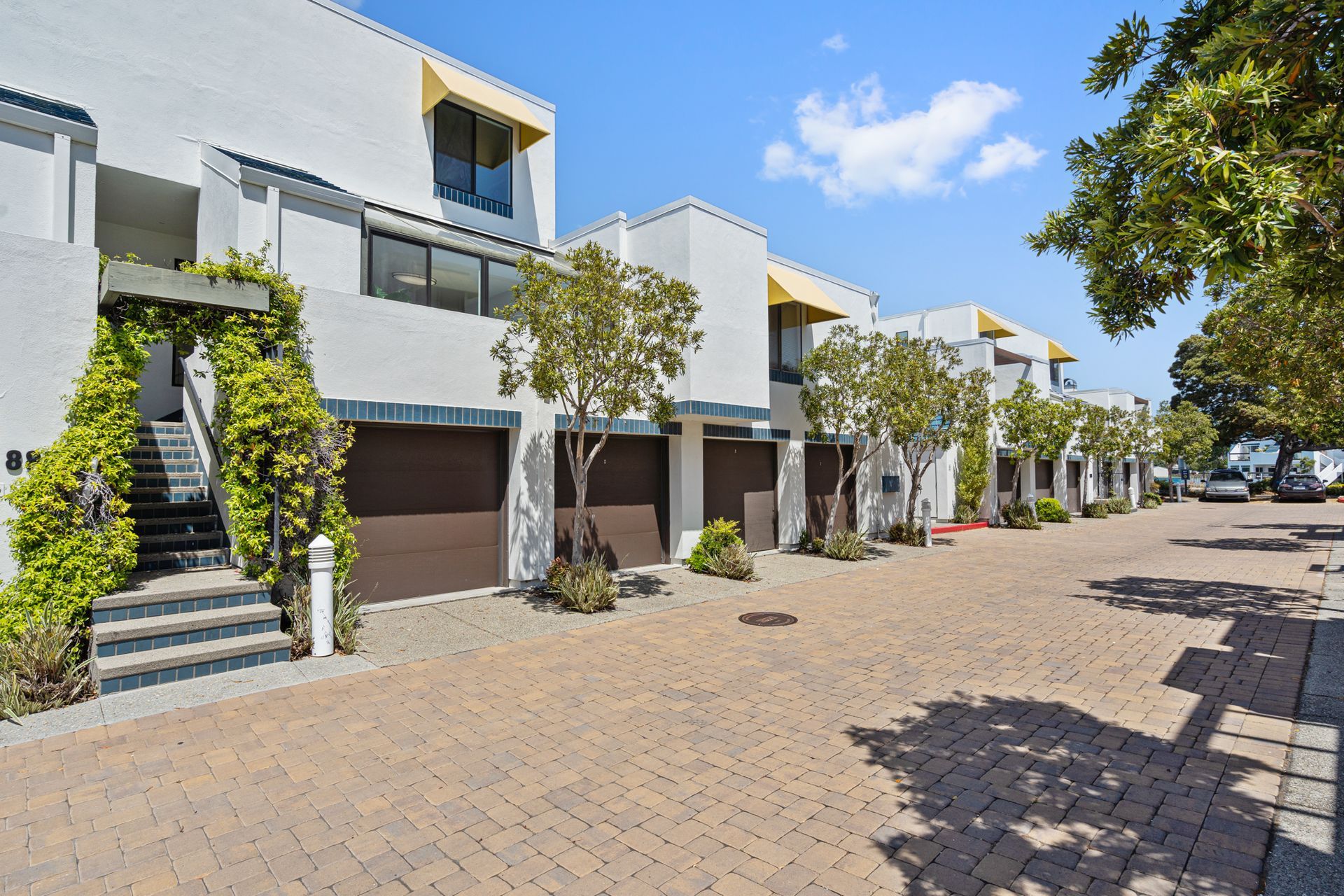 A row of white houses with brown garage doors