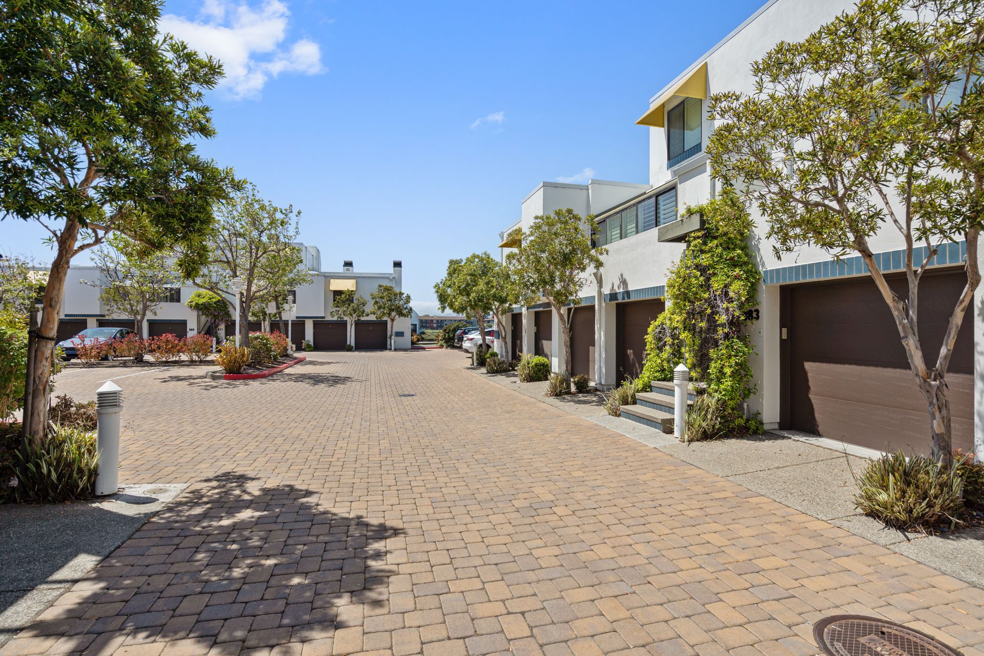 A row of houses are lined up on a cobblestone street.
