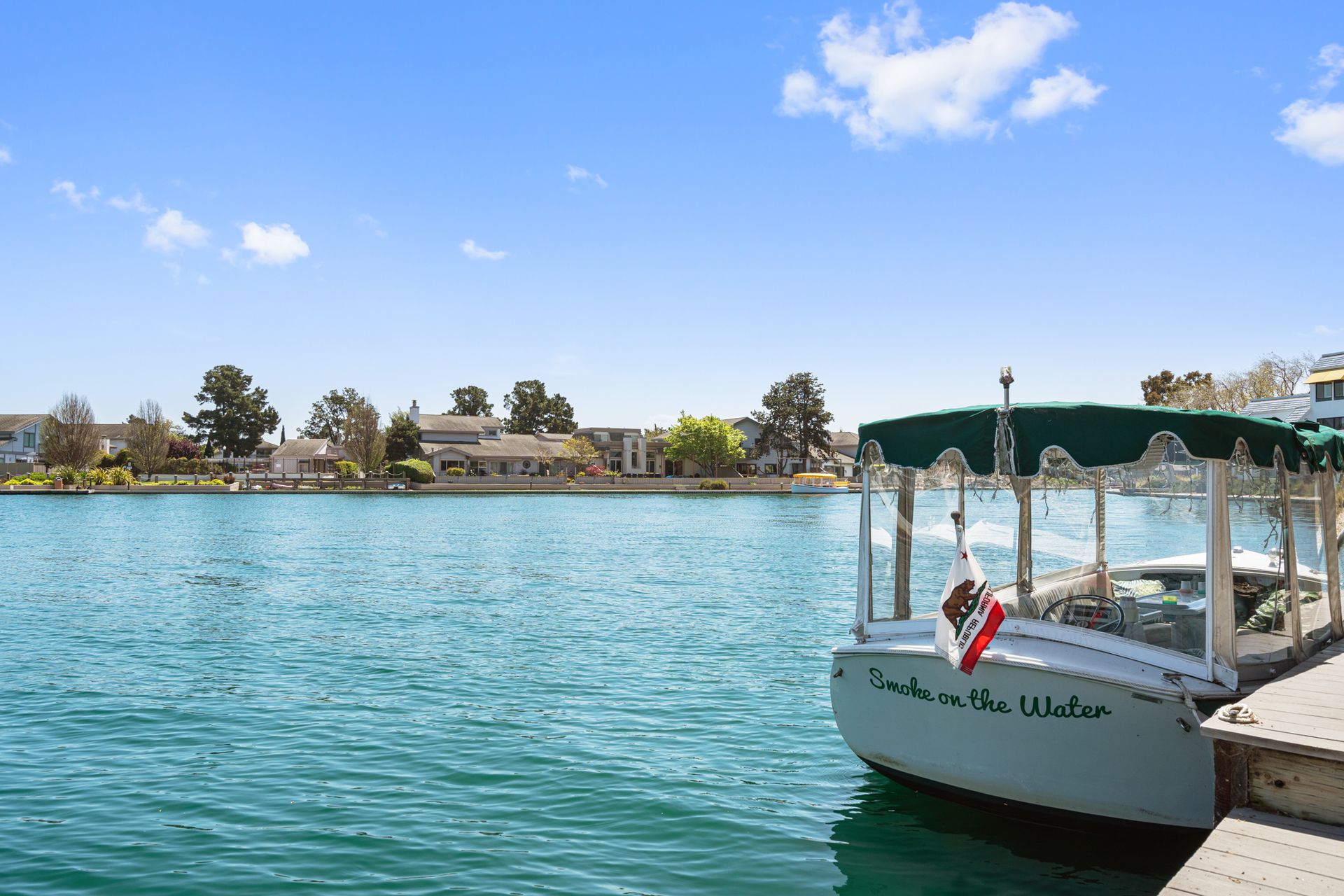 A boat is docked at a dock on a lake.
