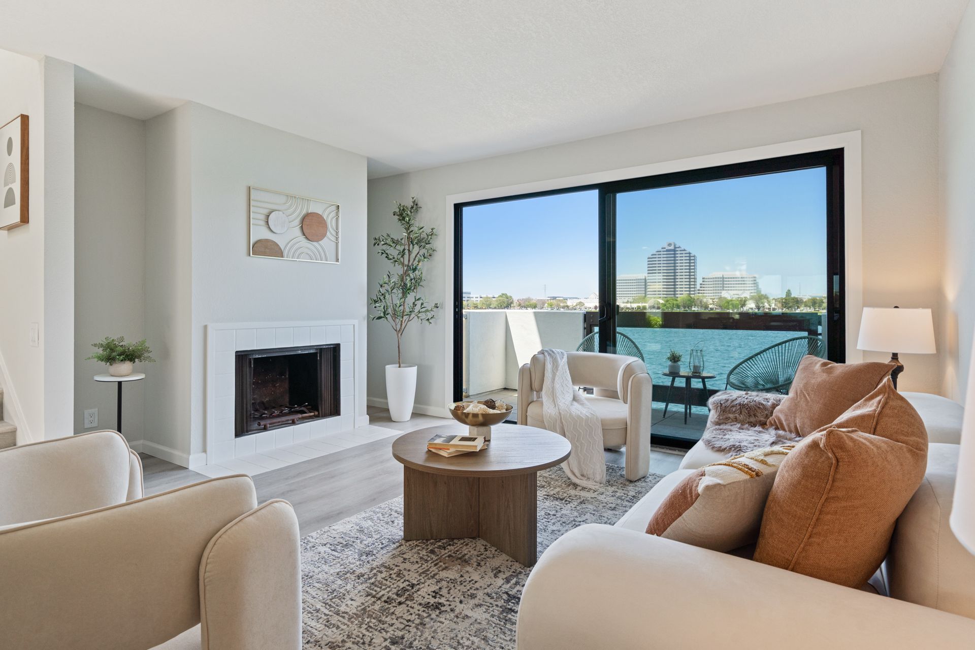 A living room with a couch , chairs , coffee table and fireplace.