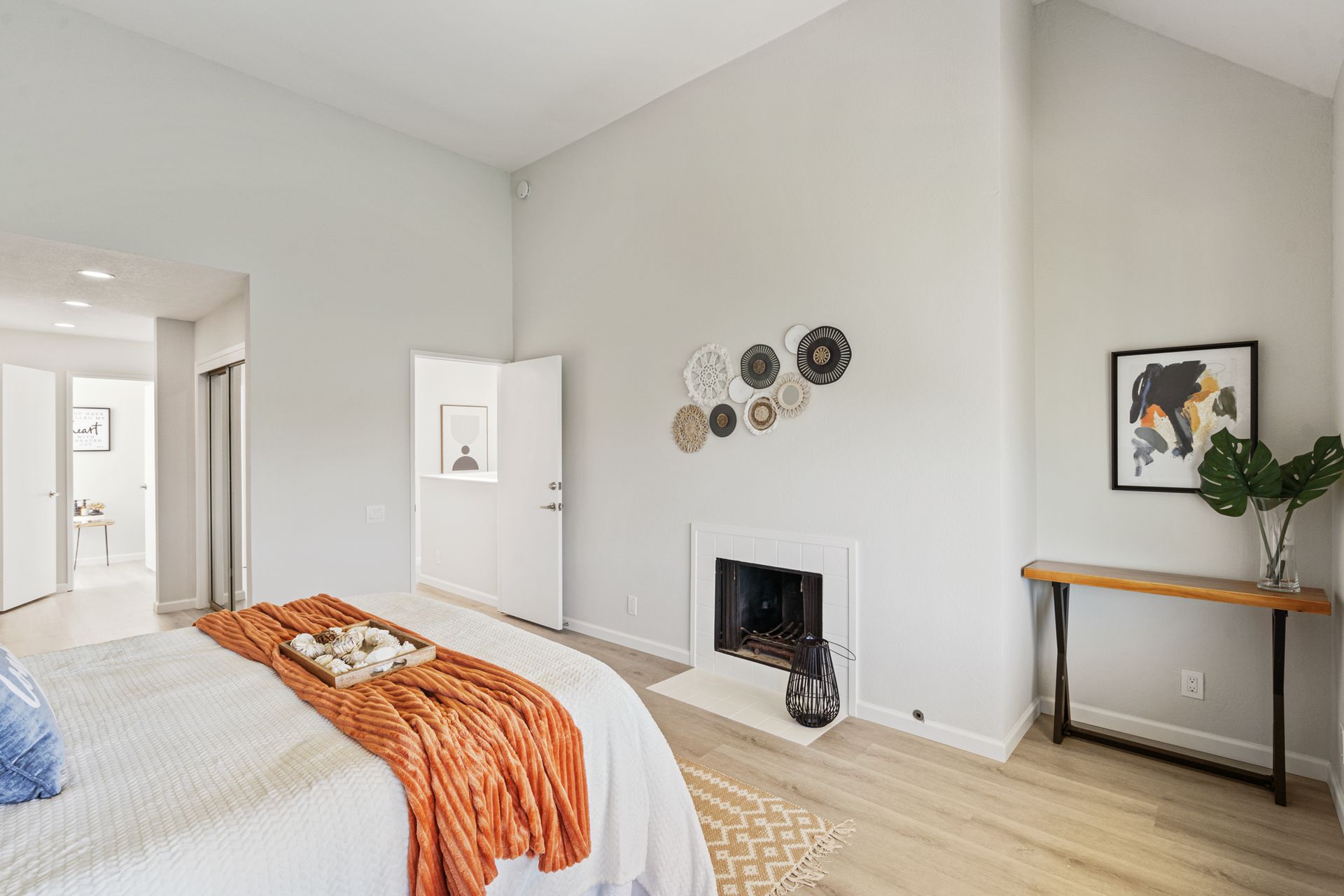 A bedroom with a fireplace and a bed.